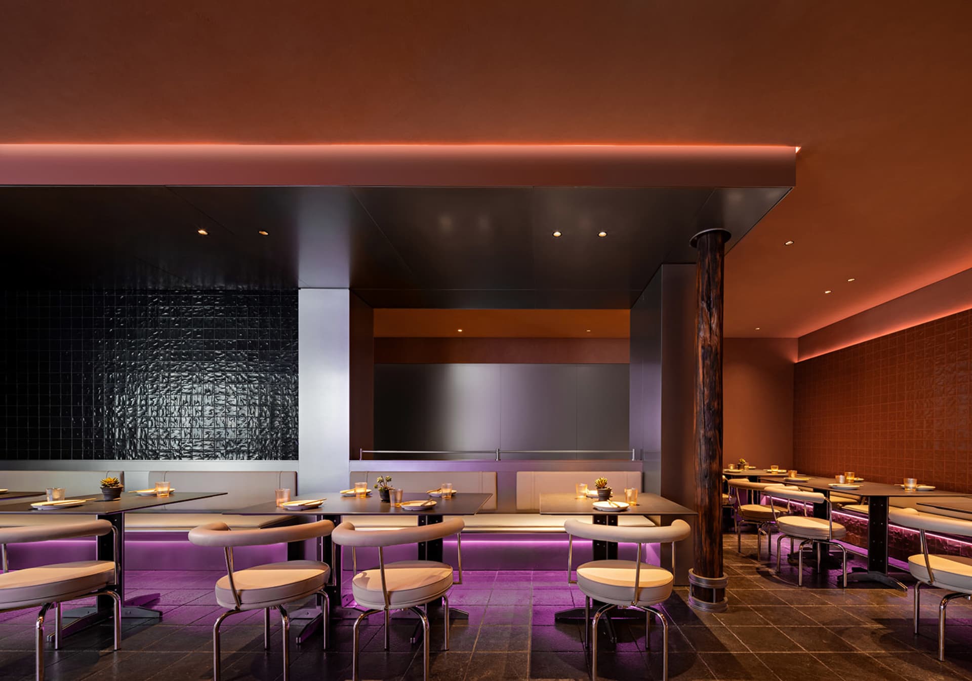 A modern, metallic-finished restaurant interior with illuminated lights.