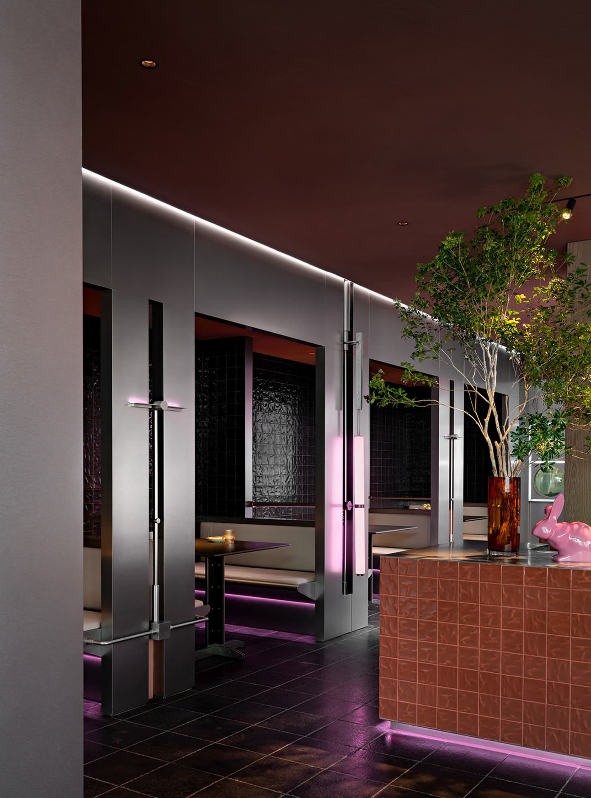 Modern, metallic, and wooden restaurant interior with glass elements.