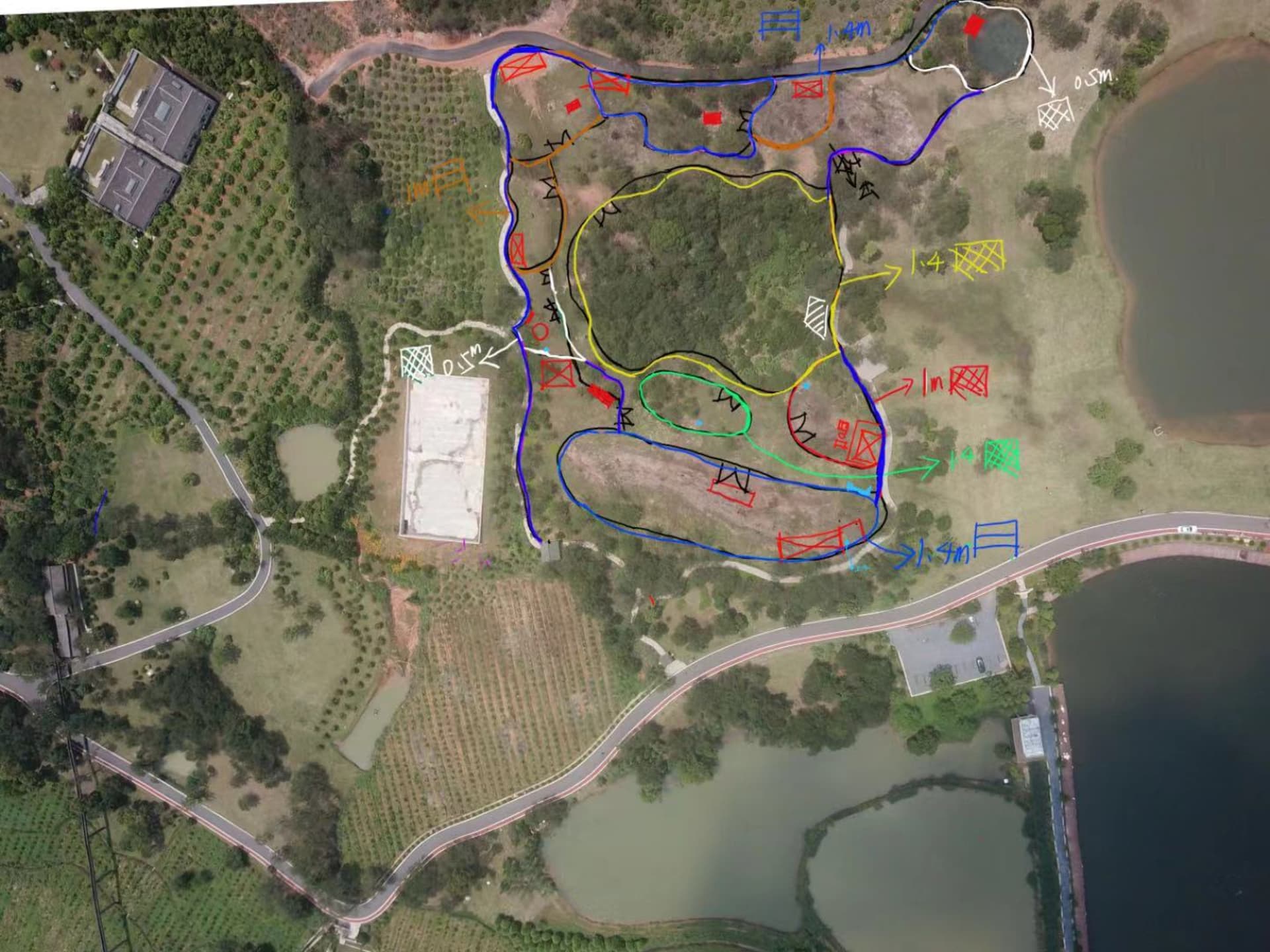 Aerial view of a park with grass, trees, and pathways.