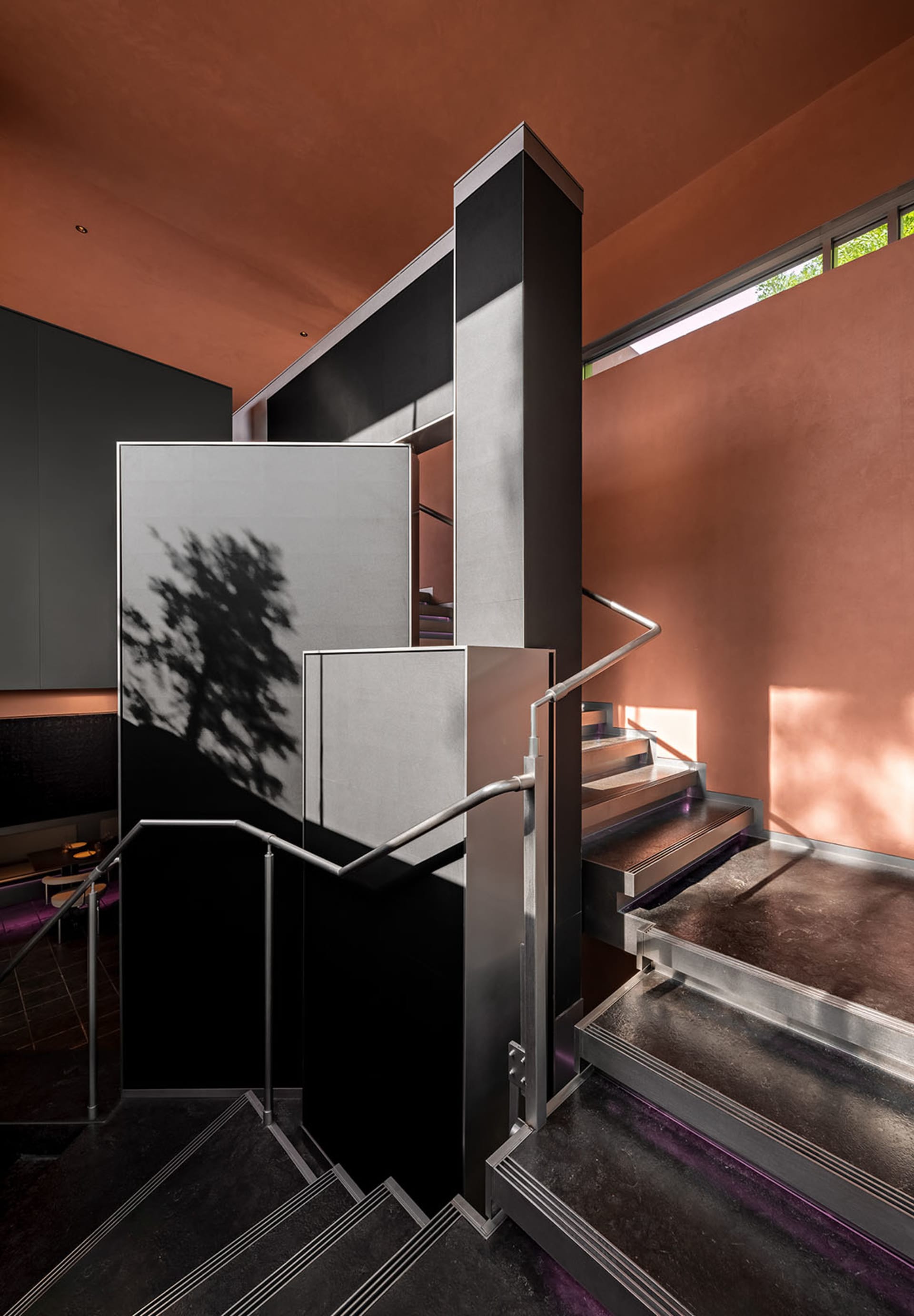 Modern interior space featuring metallic staircase with sleek design elements.