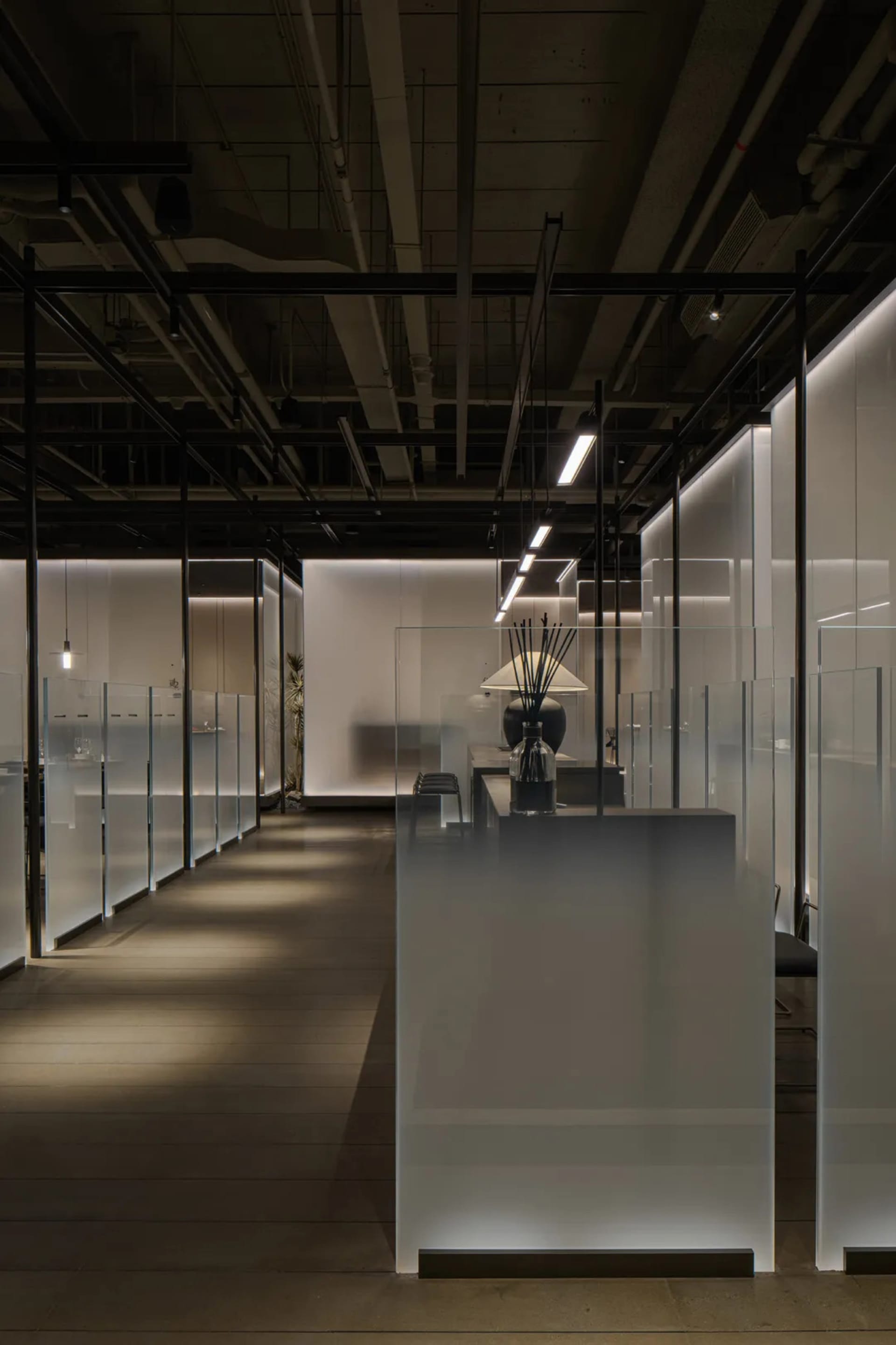 Modern office space featuring frosted glass panels and minimalist design.