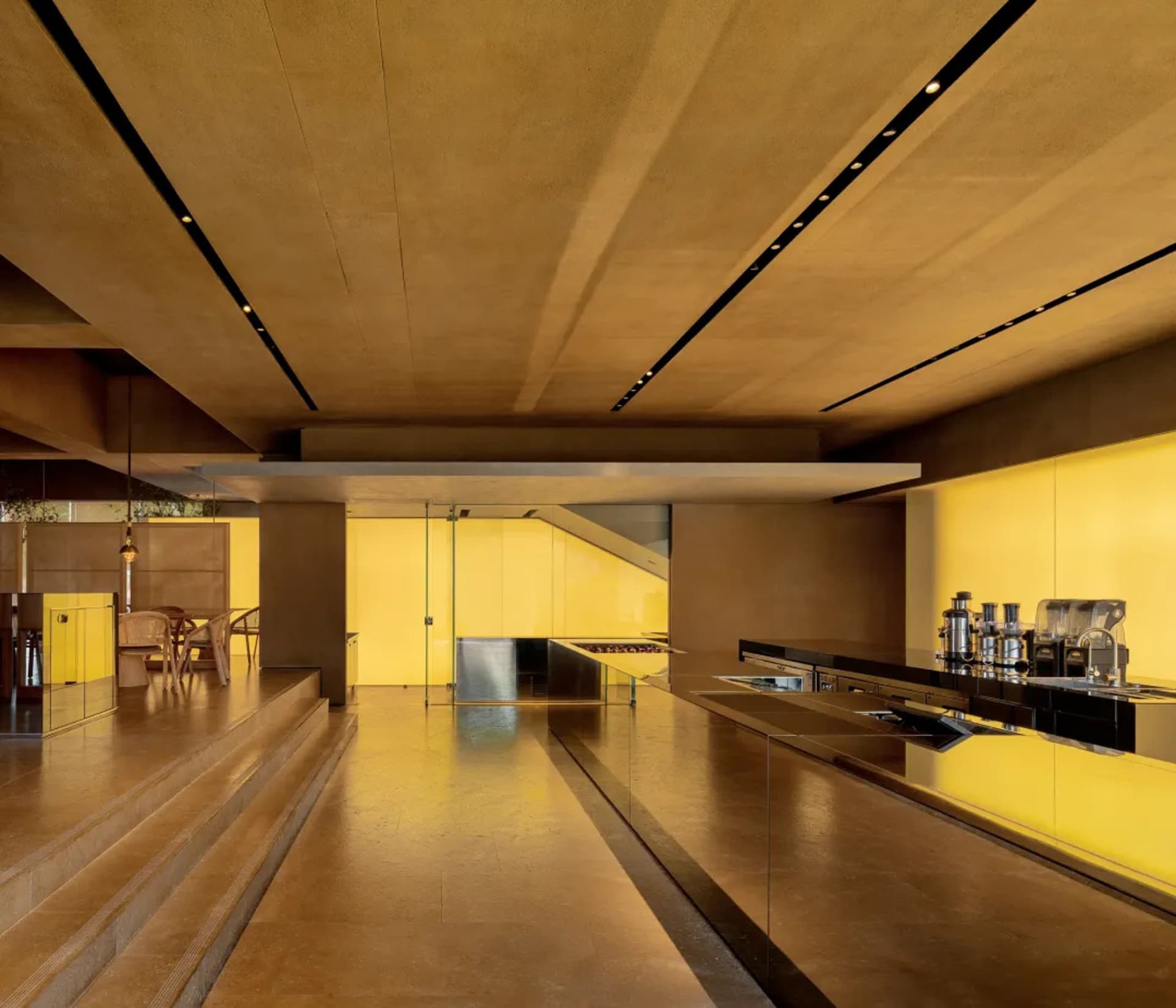Minimalist interior design featuring modern kitchen with concrete and glass materials.