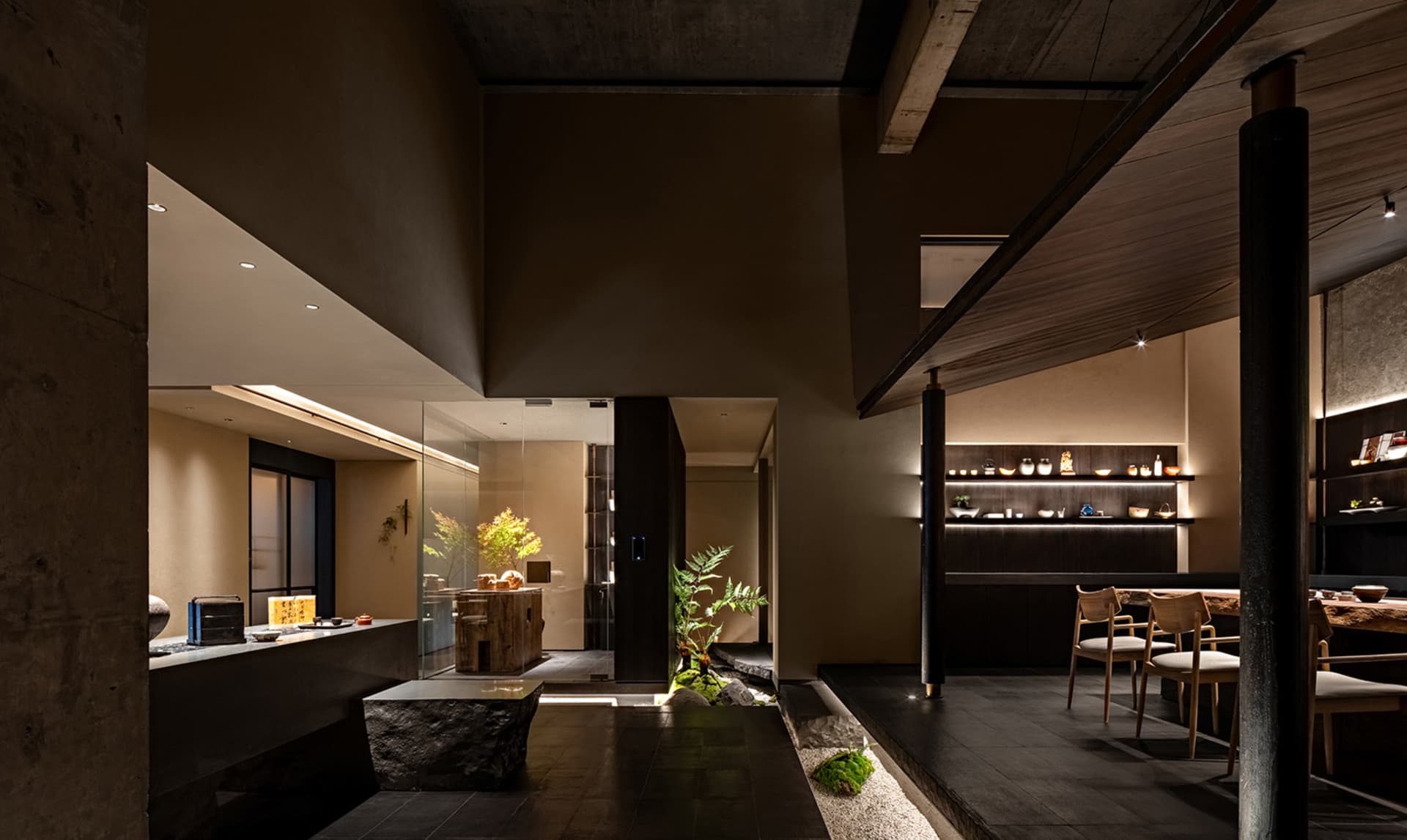 Modern restaurant interior with dark wood and concrete materials.