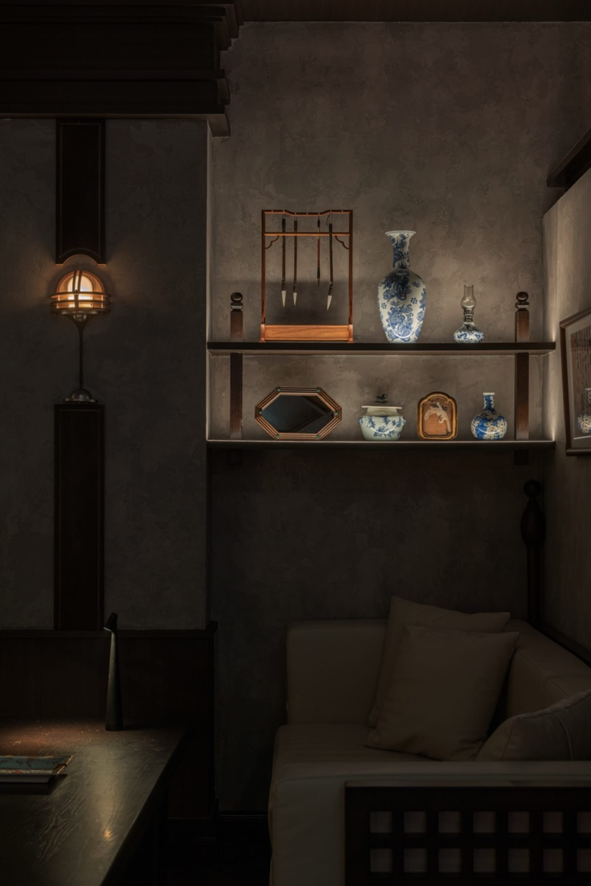 A cozy, industrial-style living room with wooden furniture, a cozy couch, and decorative items on a shelf.