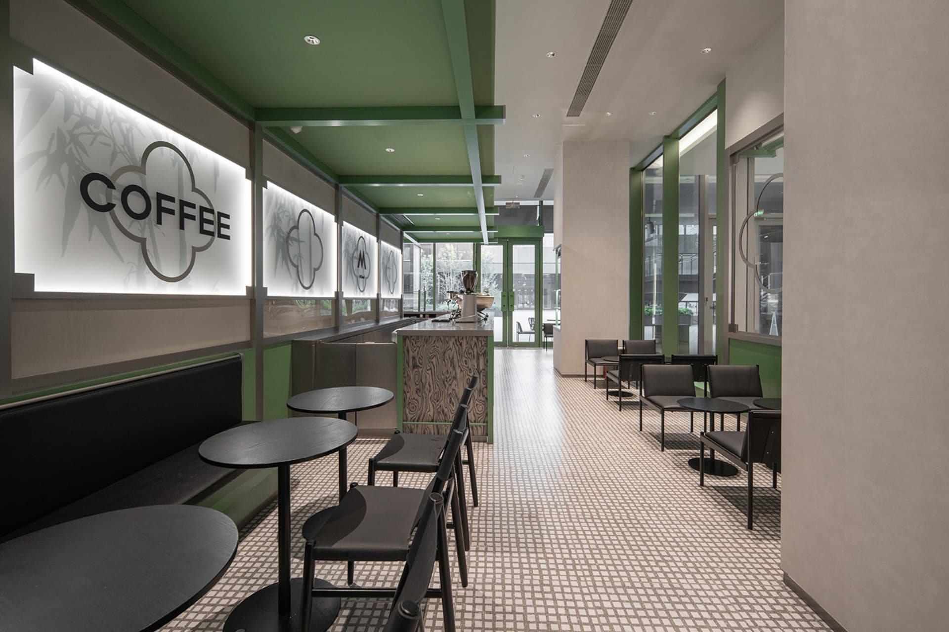 Interior design of a modern coffee shop featuring glass and steel materials.