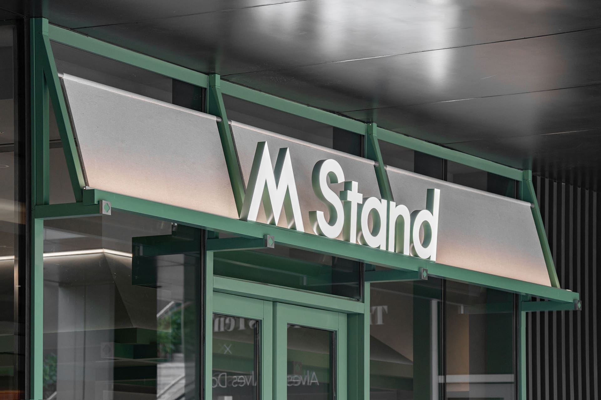 Modern retail storefront sign featuring metallic material