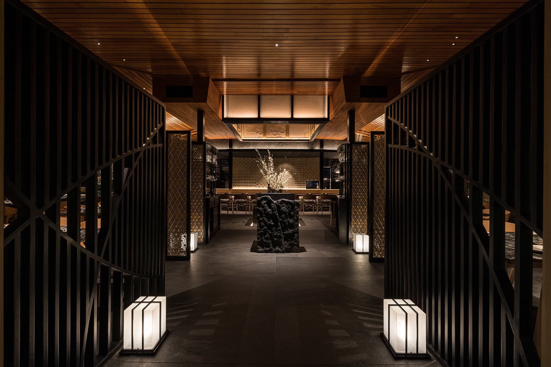 A modern restaurant interior featuring wooden materials and contemporary design elements.