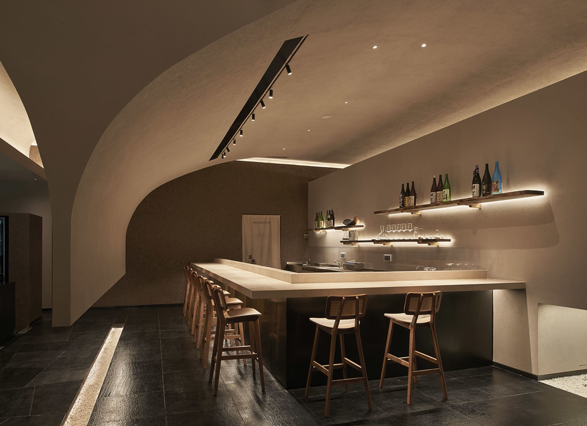 A modern industrial bar area with metal and wood elements.