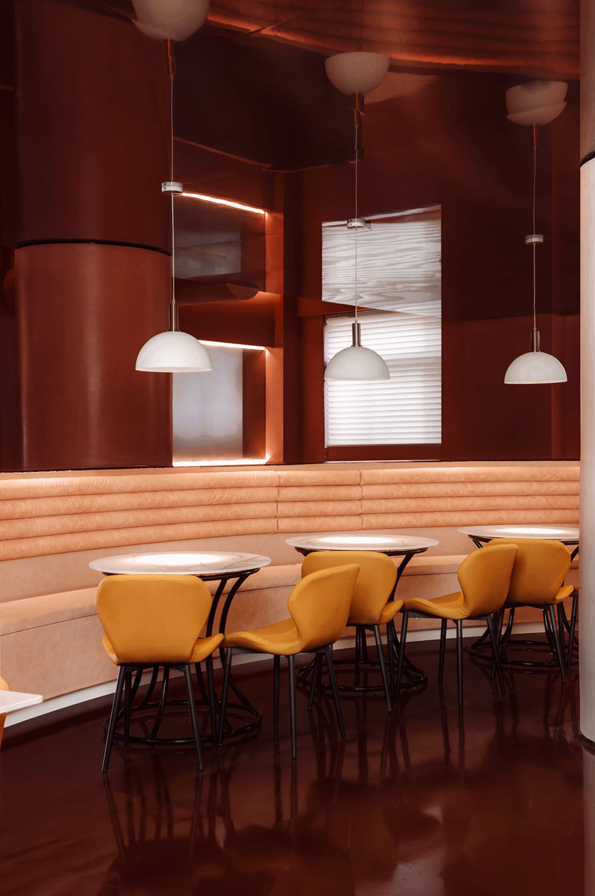 Modern industrial restaurant interior with metallic walls, leather seating, and matte finishes