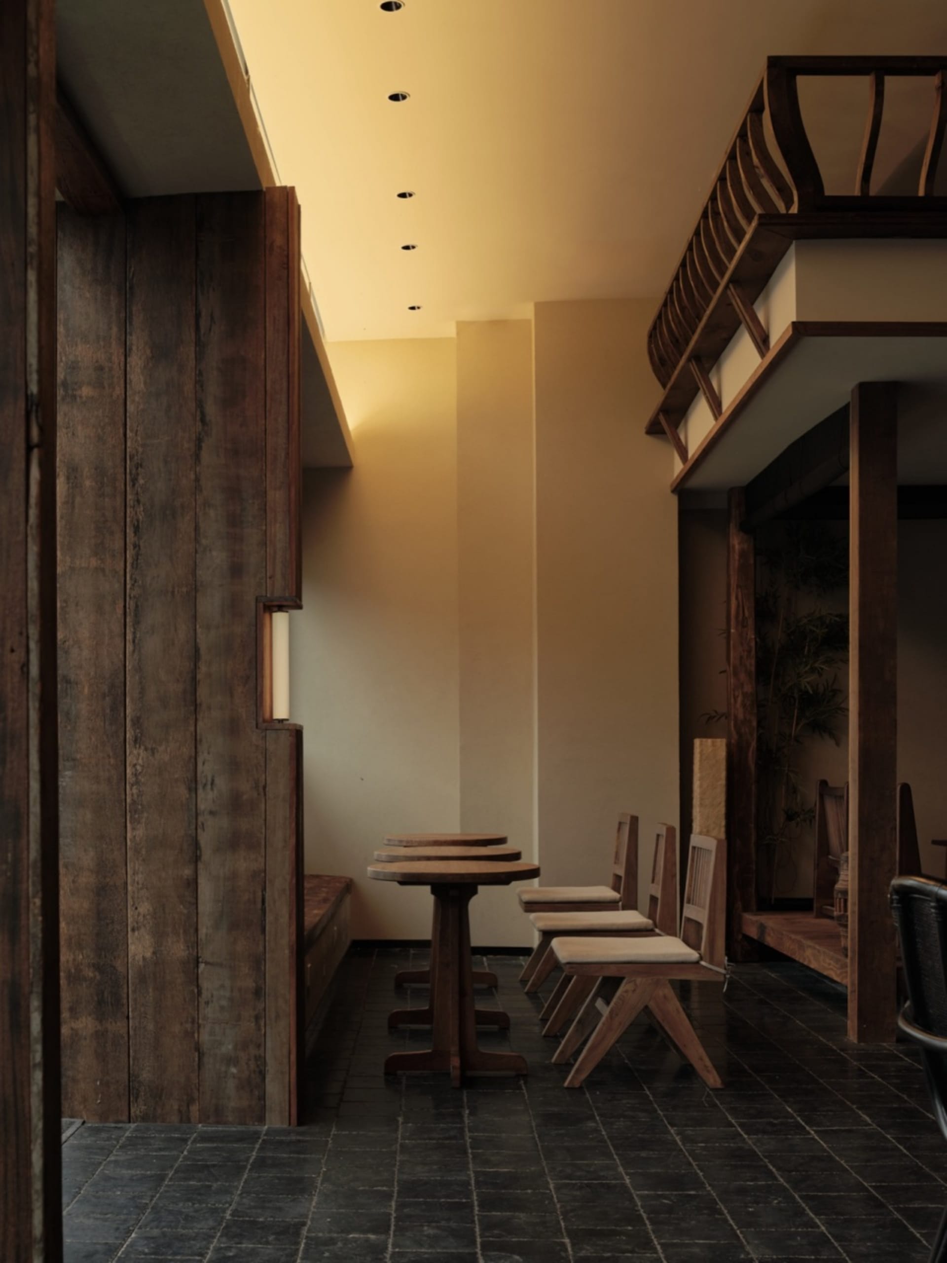 Modern minimalist cafe interior featuring wooden tables and chairs