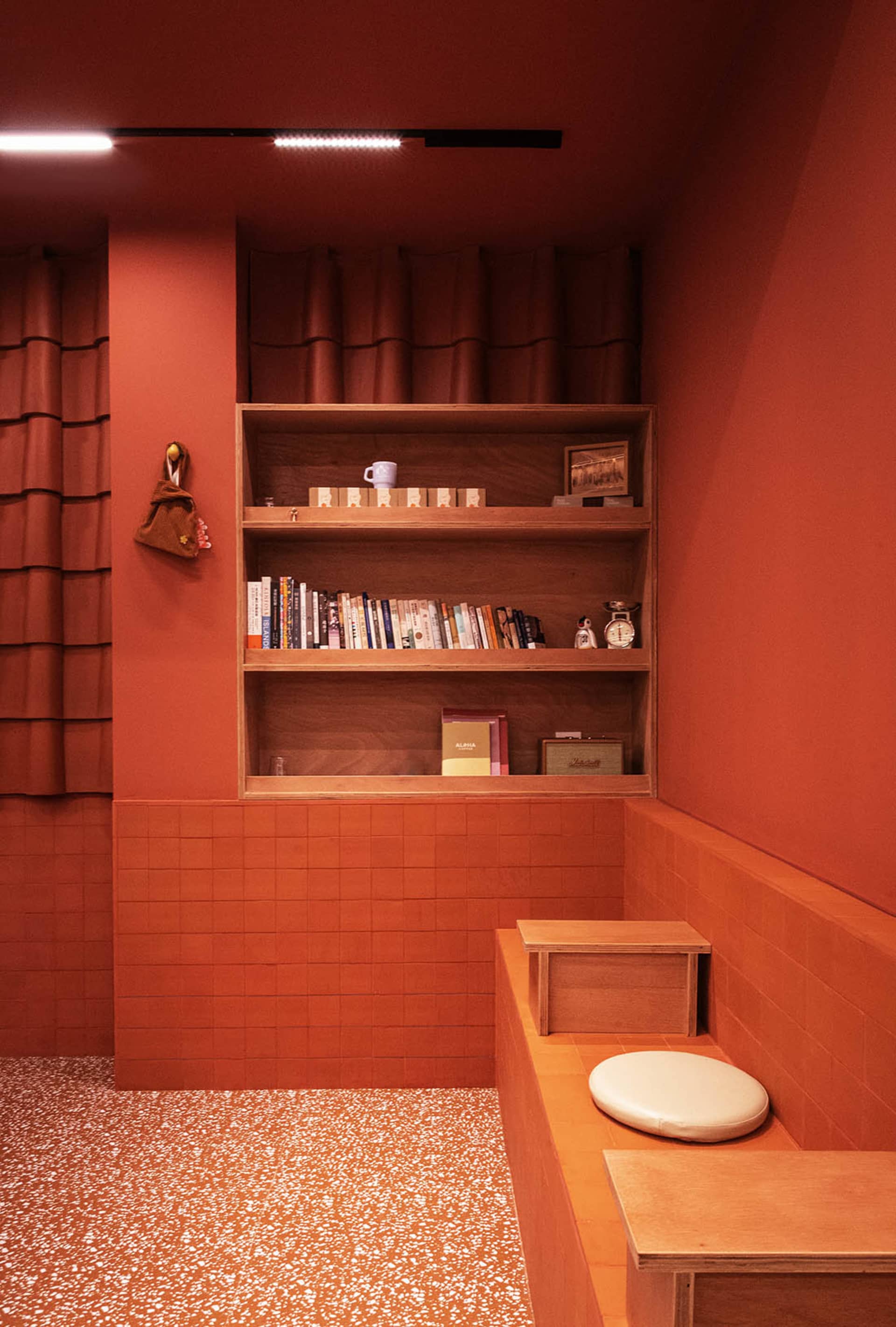 A modern industrial office space featuring exposed concrete walls and brick accents.