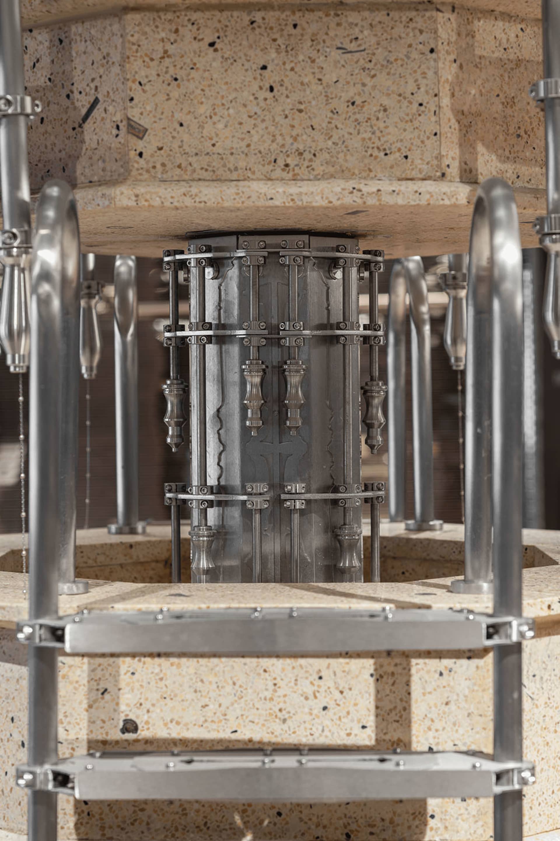 An industrial machine with metallic components and a concrete base.