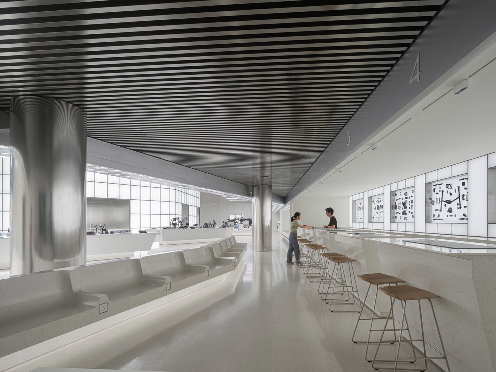 Modern interior design featuring concrete, metal, and glass materials.