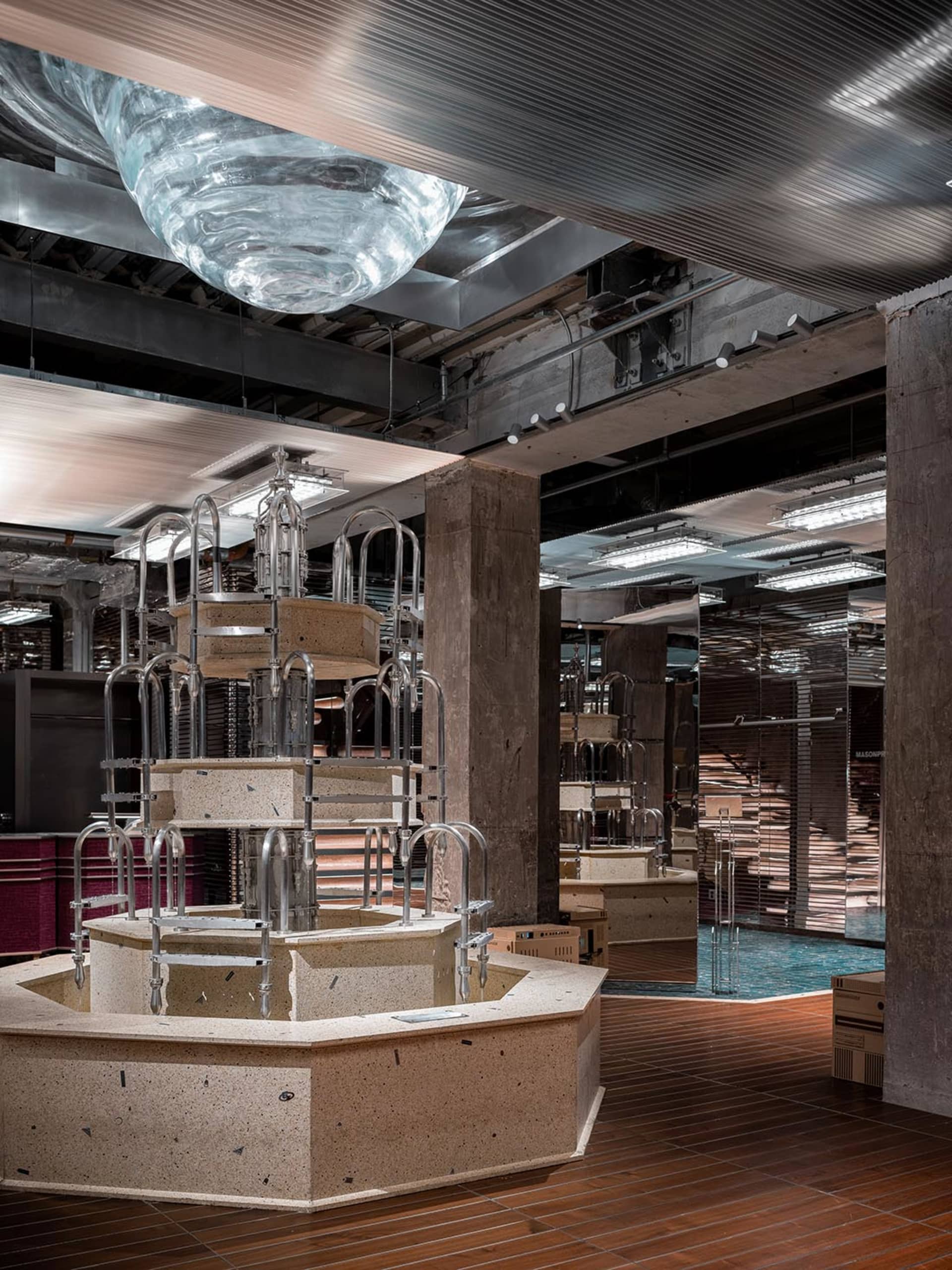Industrial-style restaurant interior with concrete, glass, and metal elements