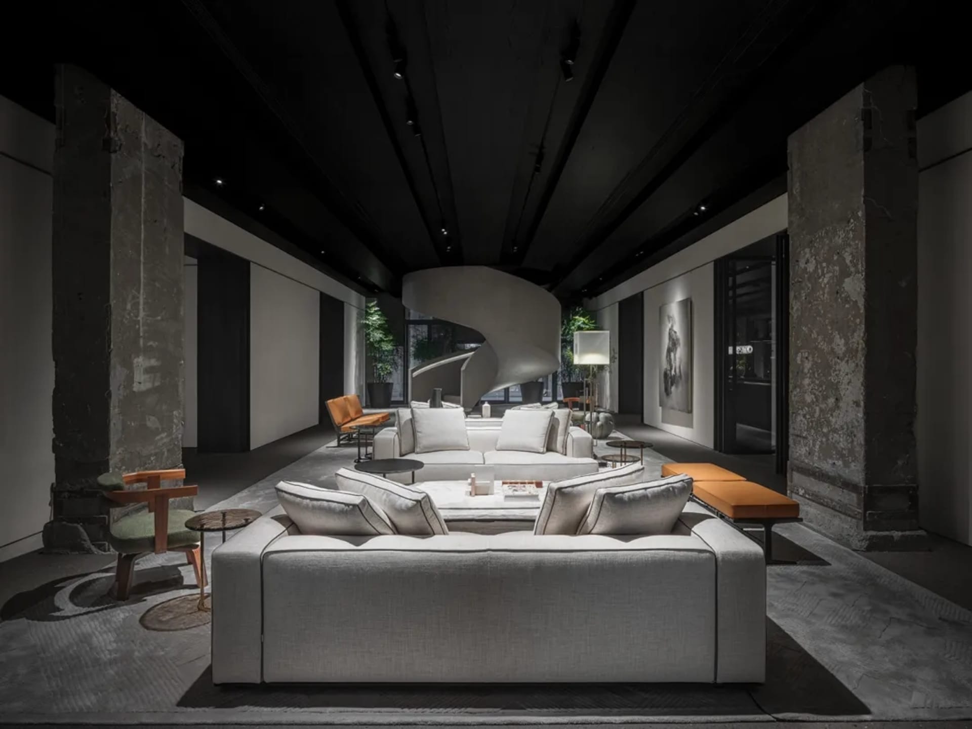 Modern living room with concrete walls and spiral staircase