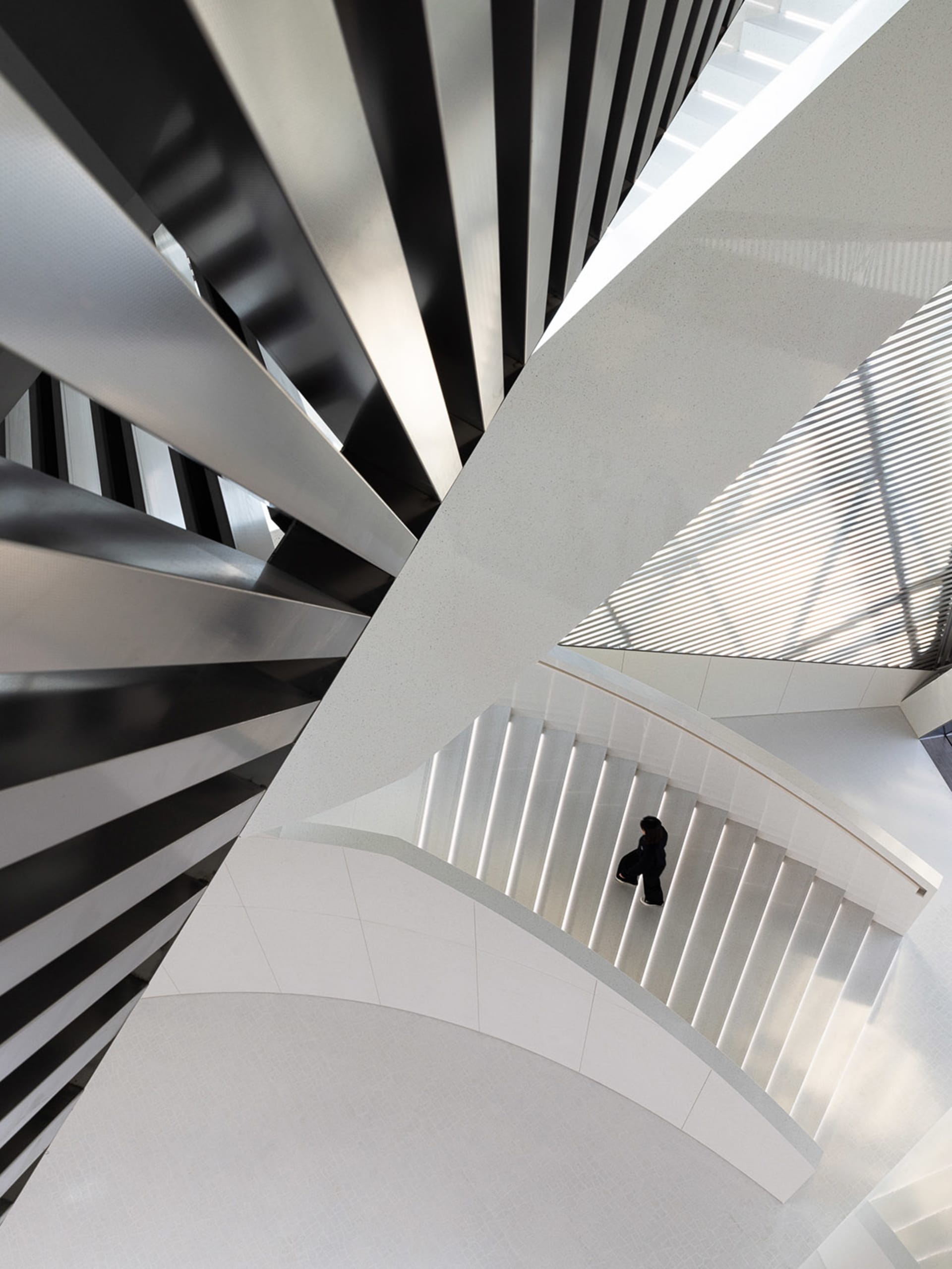 An architectural staircase with metallic white design elements.