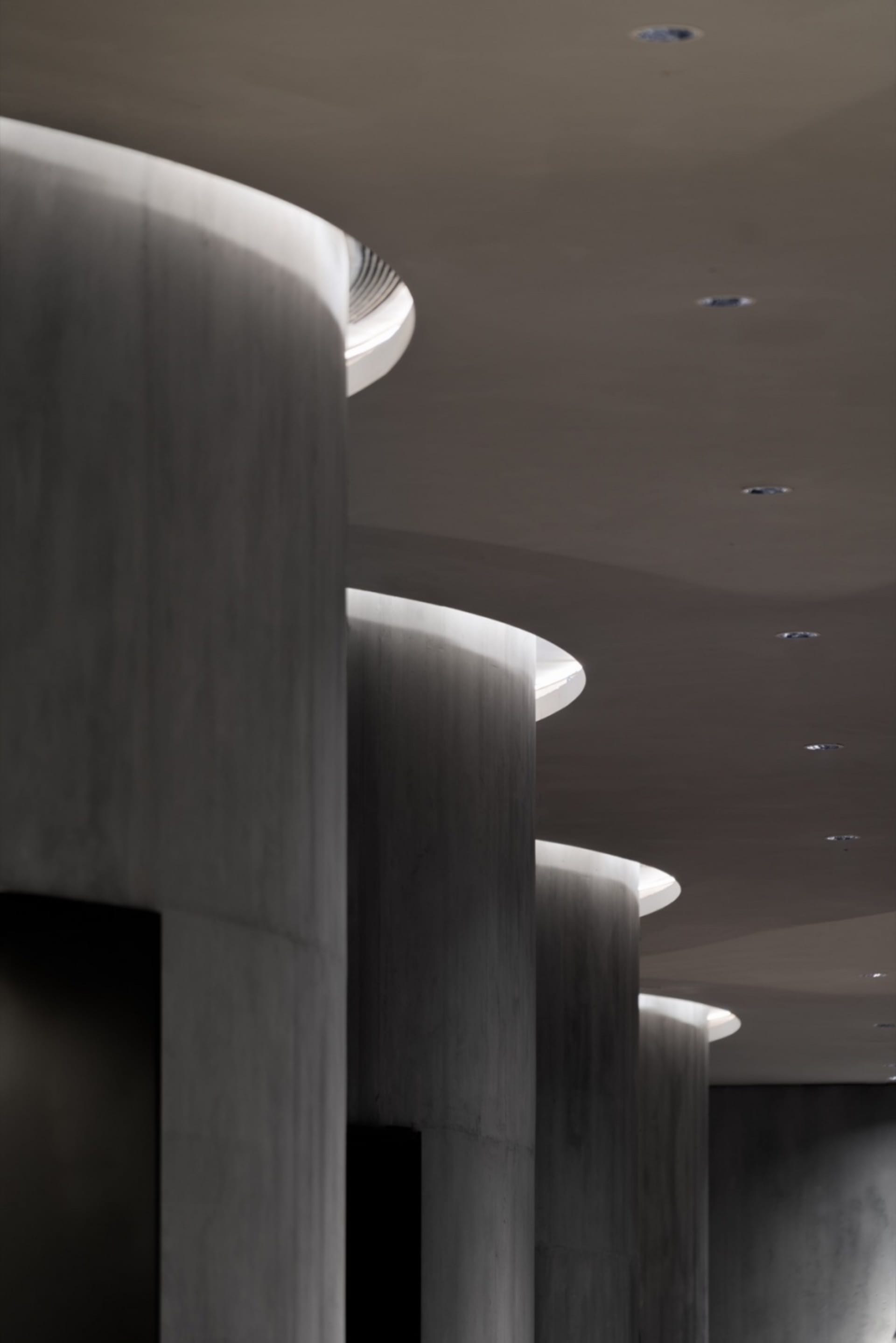 A modern interior design featuring concrete columns