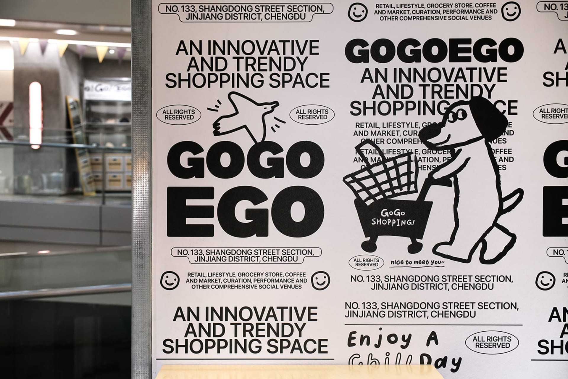Poster for the GogoEgo Shopping Center featuring black and white graphics and text.