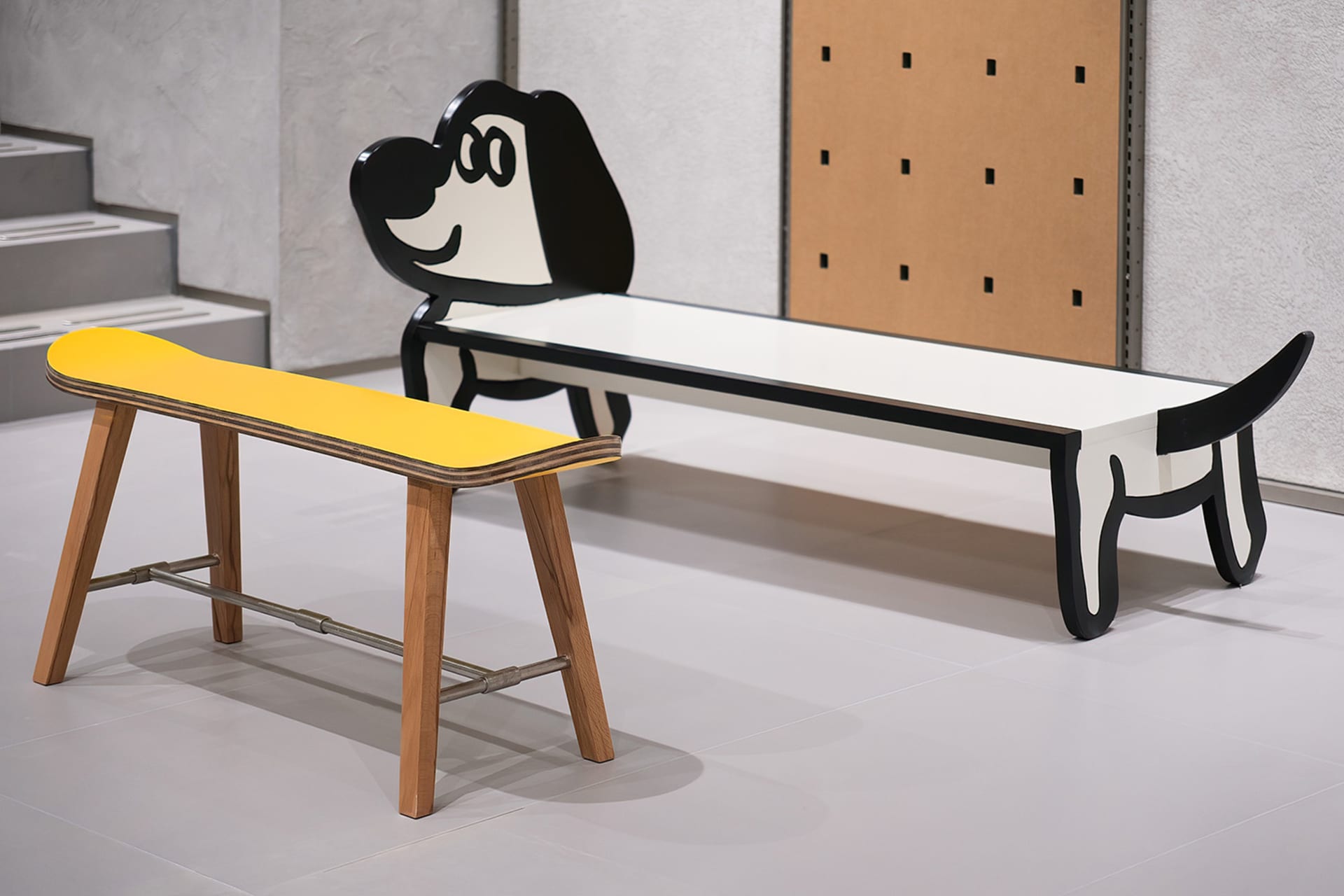 Modern industrial furniture with a yellow wooden seat and black legs.