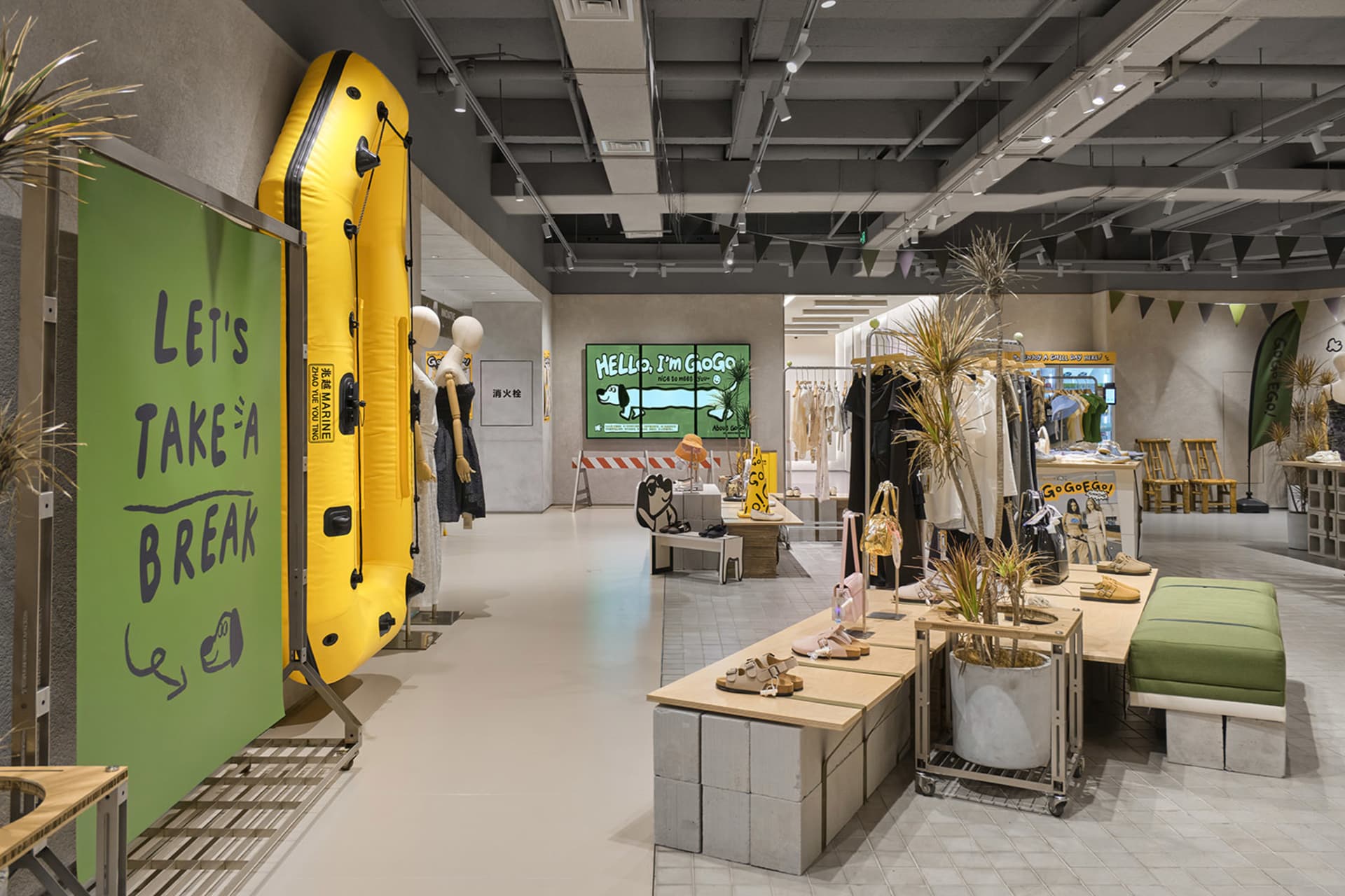 A modern retail interior space with concrete materials, showcasing clothing and accessories.