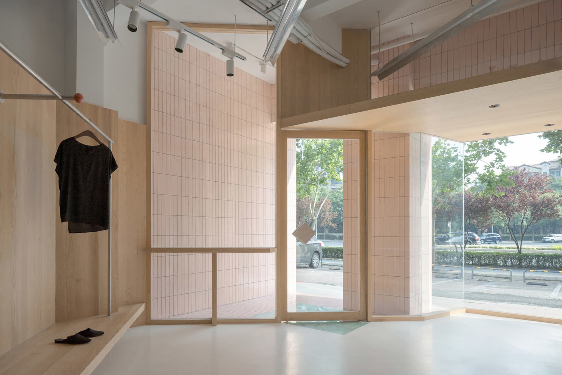 Modern retail storefront with wooden walls, glass doors, and tiled floor