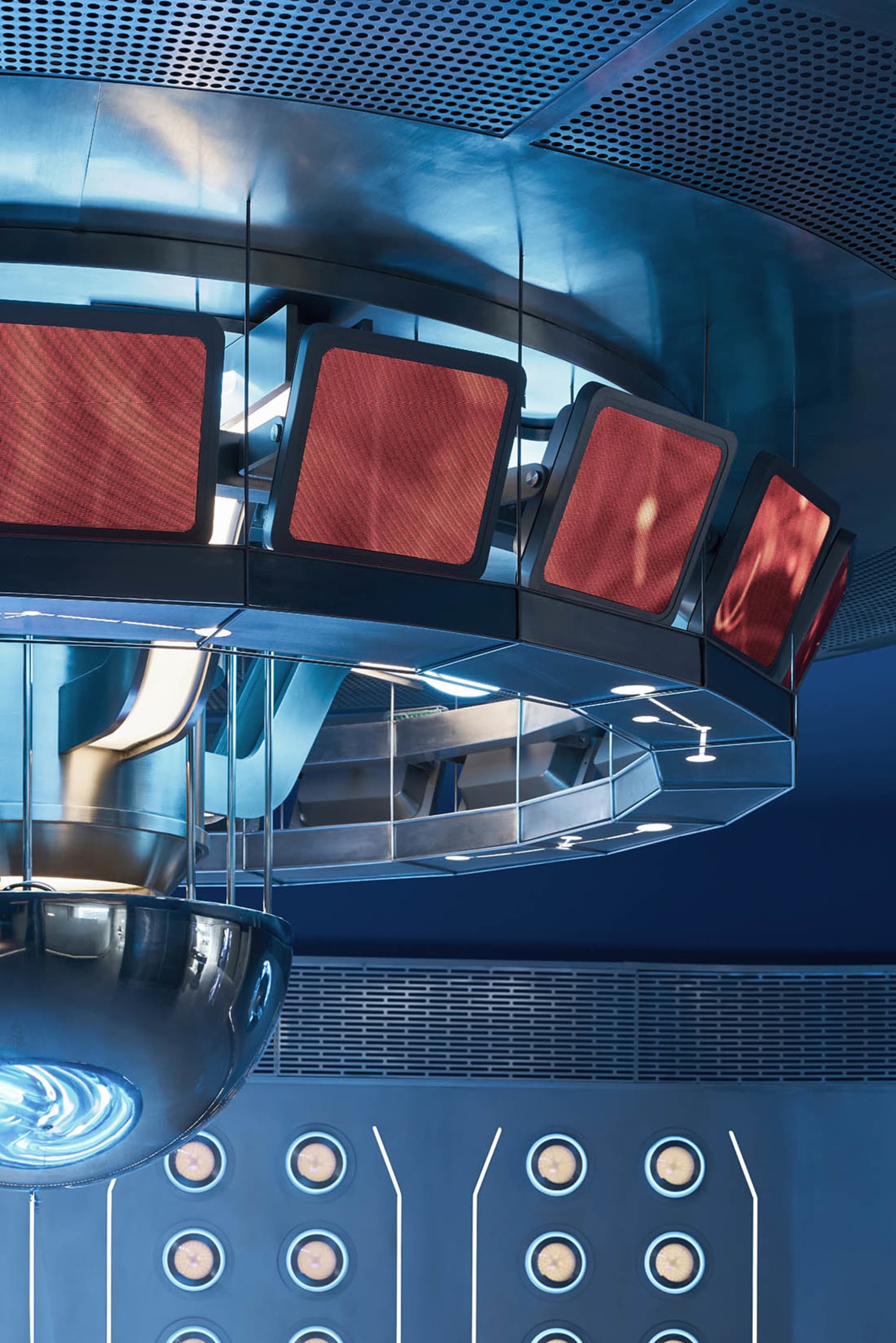 High-tech, industrial design features in a futuristic dining and conference suite with metallic materials and advanced lighti