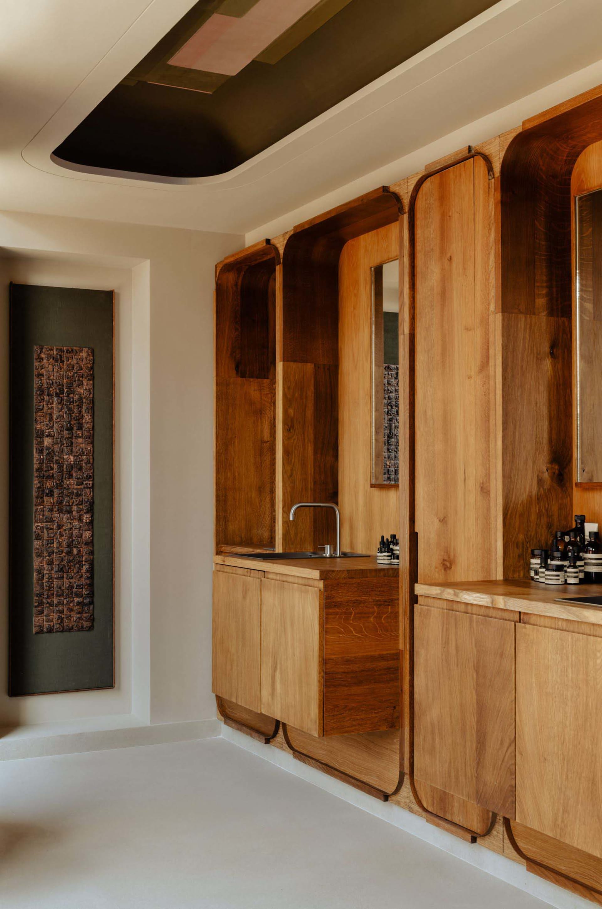 Modern, minimalist bathroom featuring wood accents and a sleek design.