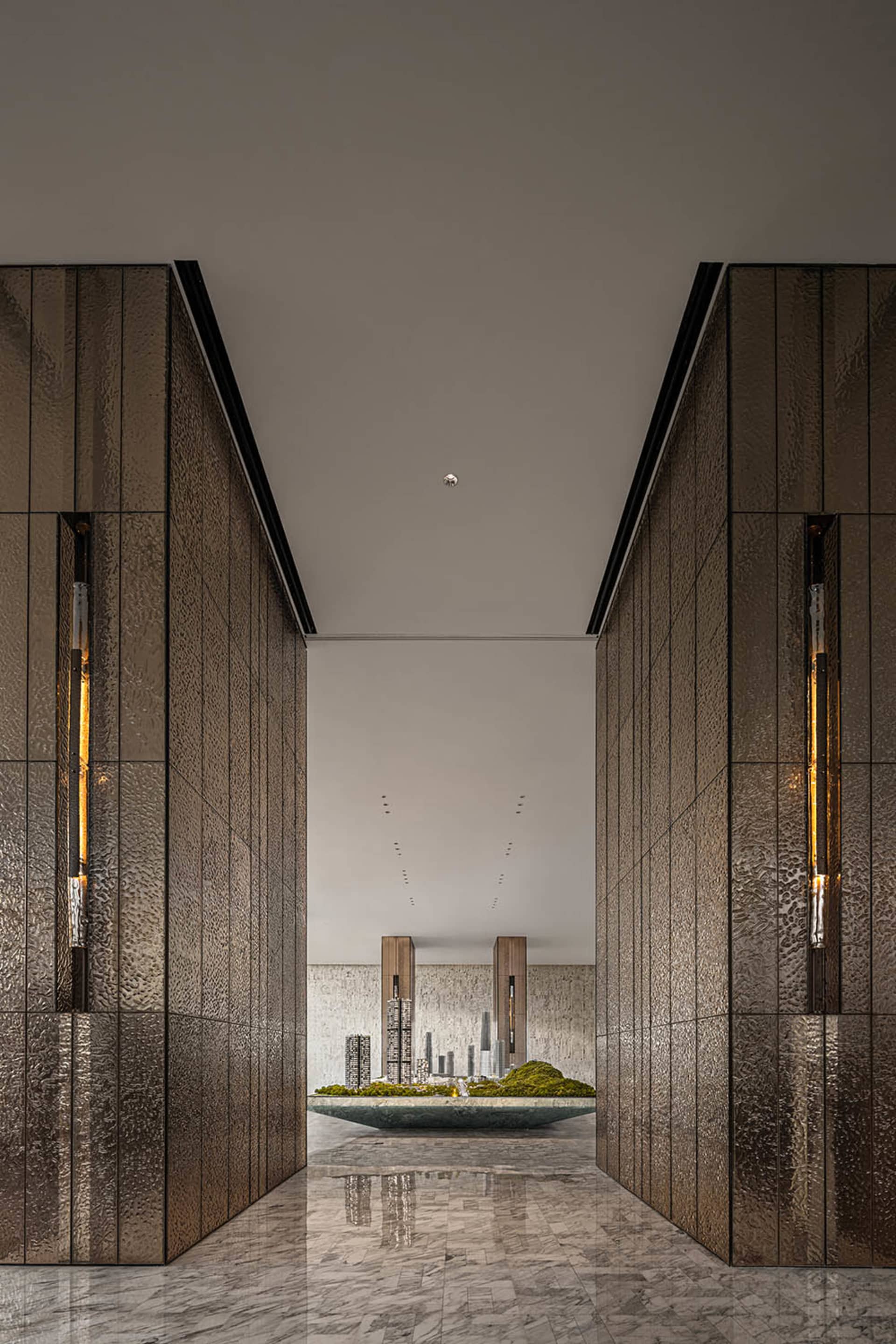 Modern lobby with metallic textured walls and marble flooring