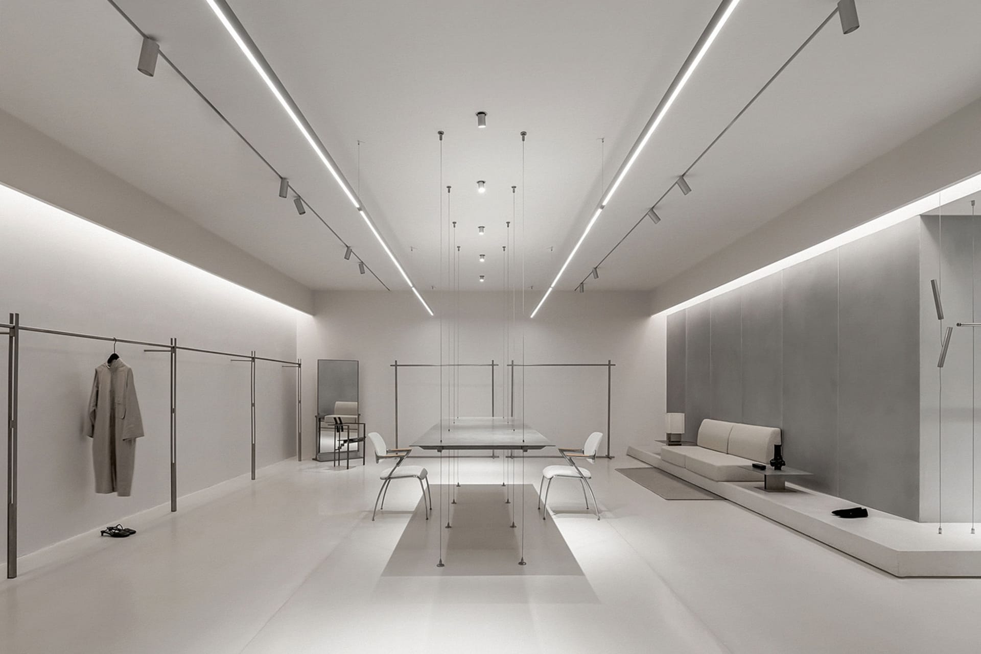 Modern minimalist retail store featuring metal, glass, and white materials