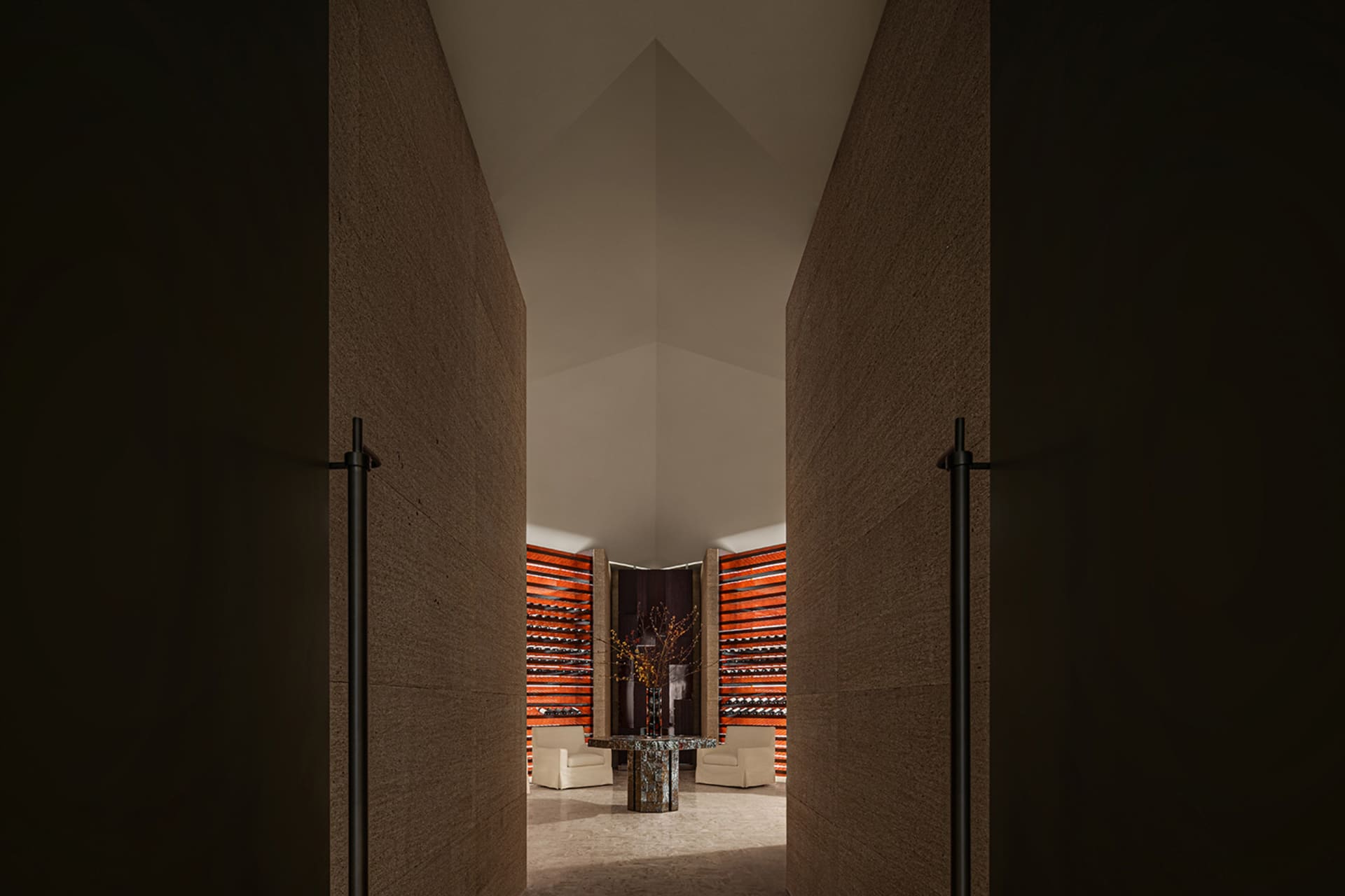 Modern interior with concrete walls and a central table with chairs.