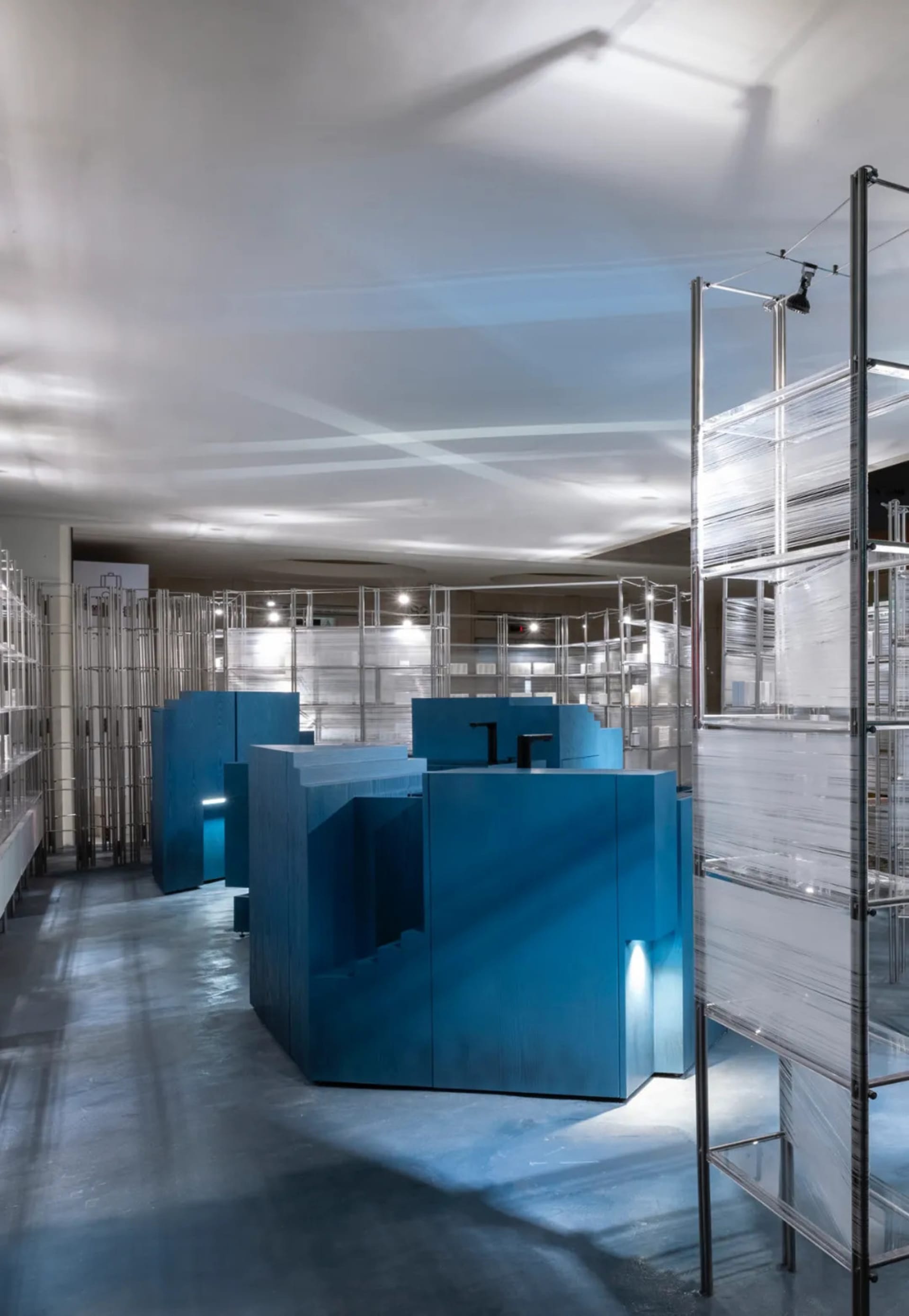 Modern retail space featuring blue retailing counters in a contemporary design.