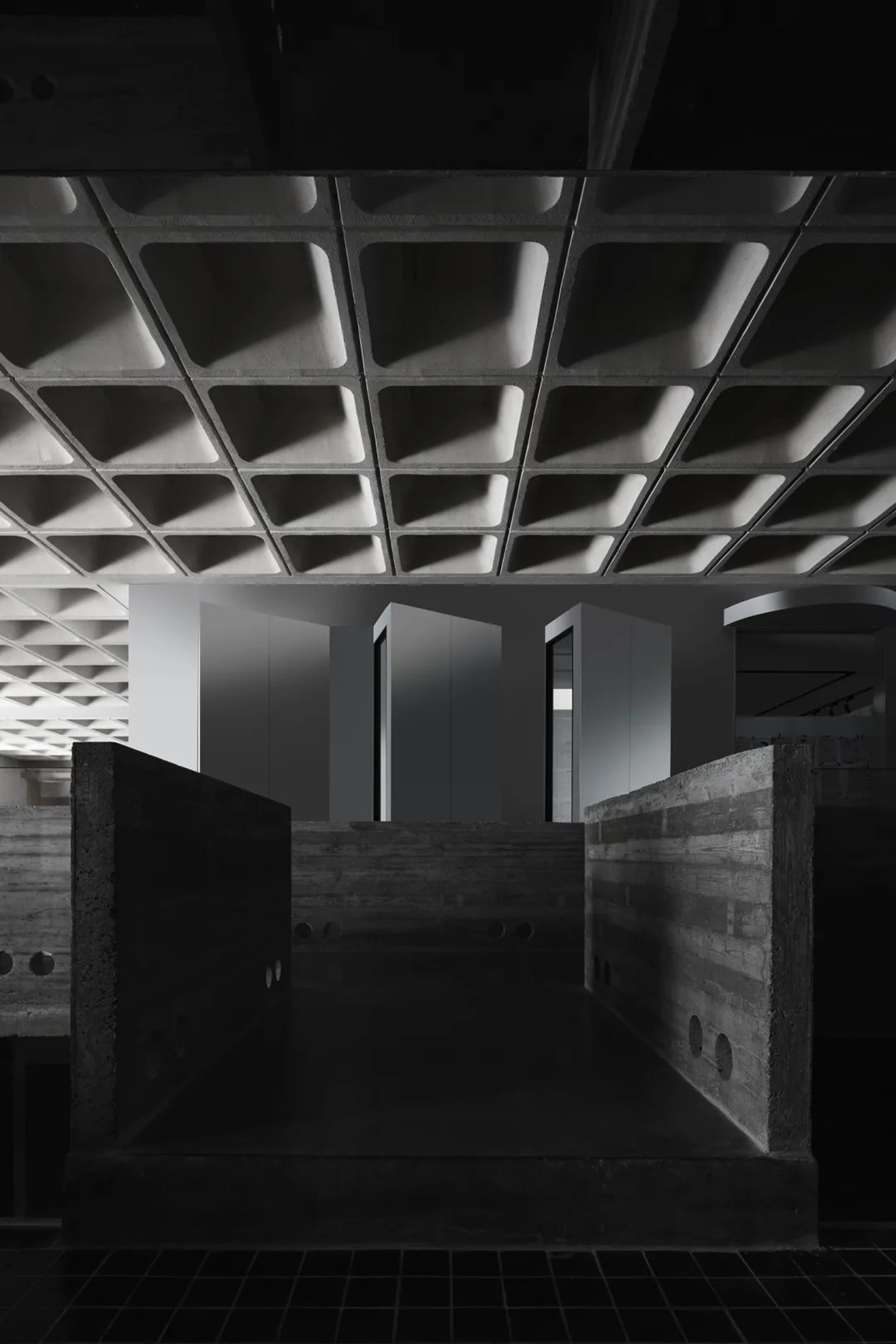 A contemporary office space featuring concrete and glass materials.