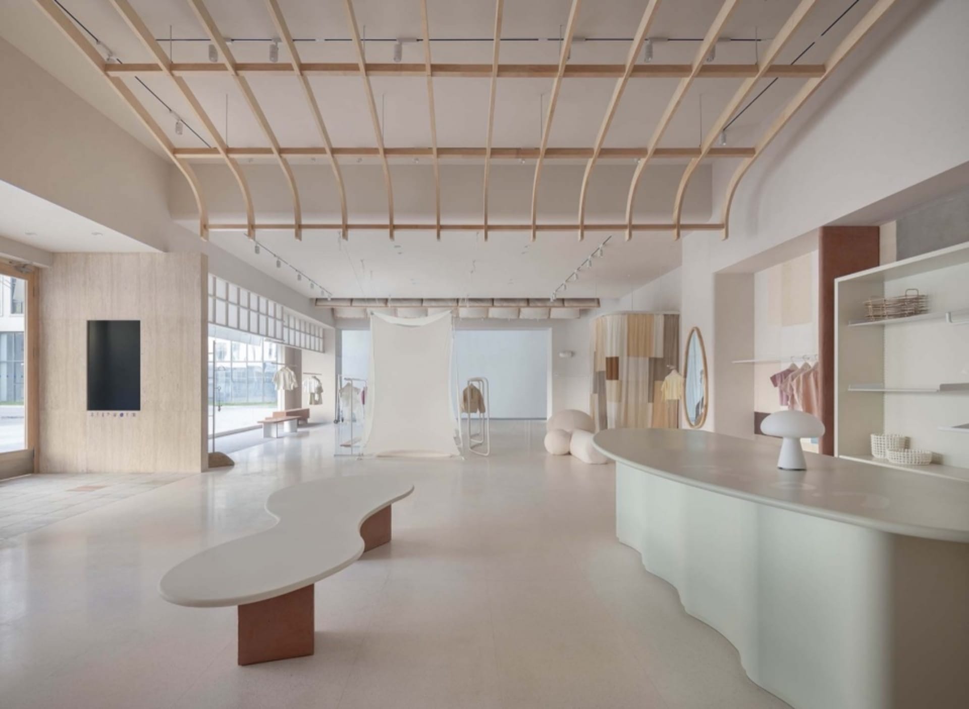 Modern retail storefront featuring clean lines, concrete surfaces, wooden accents, and glass display cases.