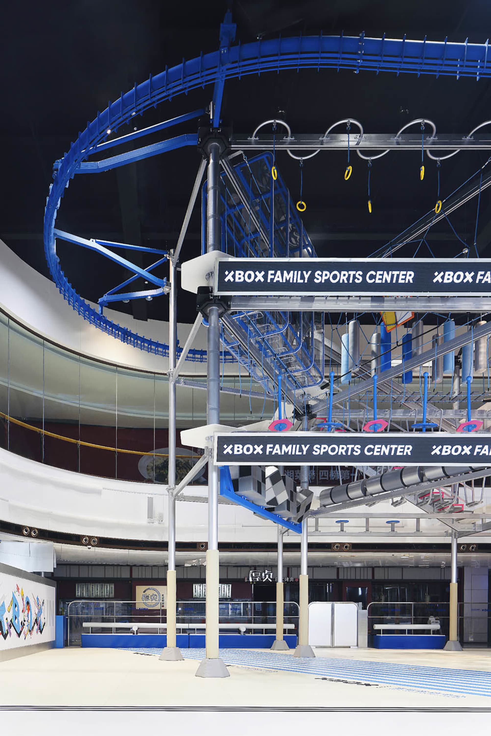 Circular metal structure and staircases of an industrial-themed Xbox Sports Center