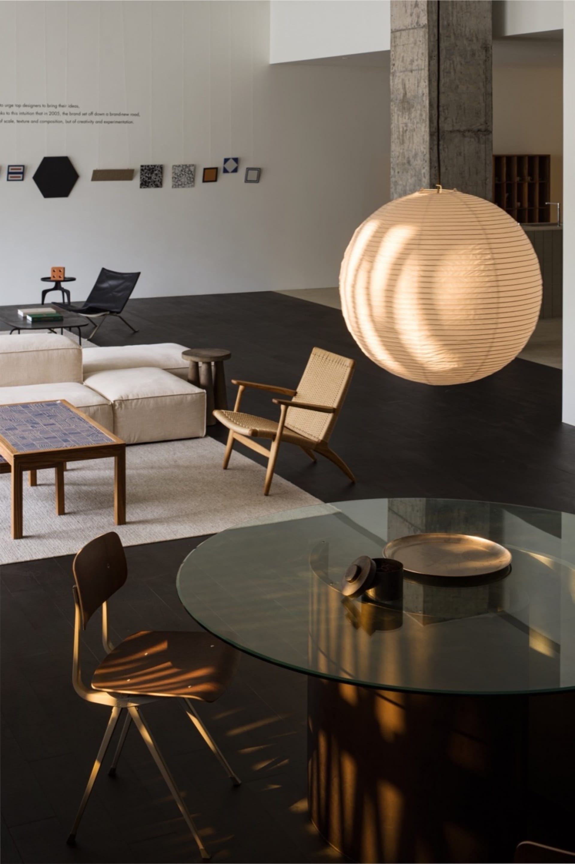 Modern minimalist living room featuring glass and wood furniture and decor.