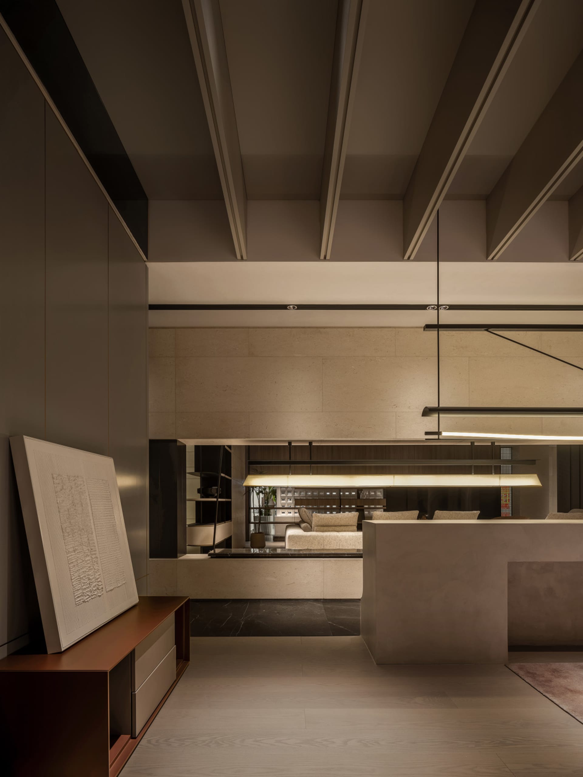 A spacious, minimalist modern living room with concrete accents.