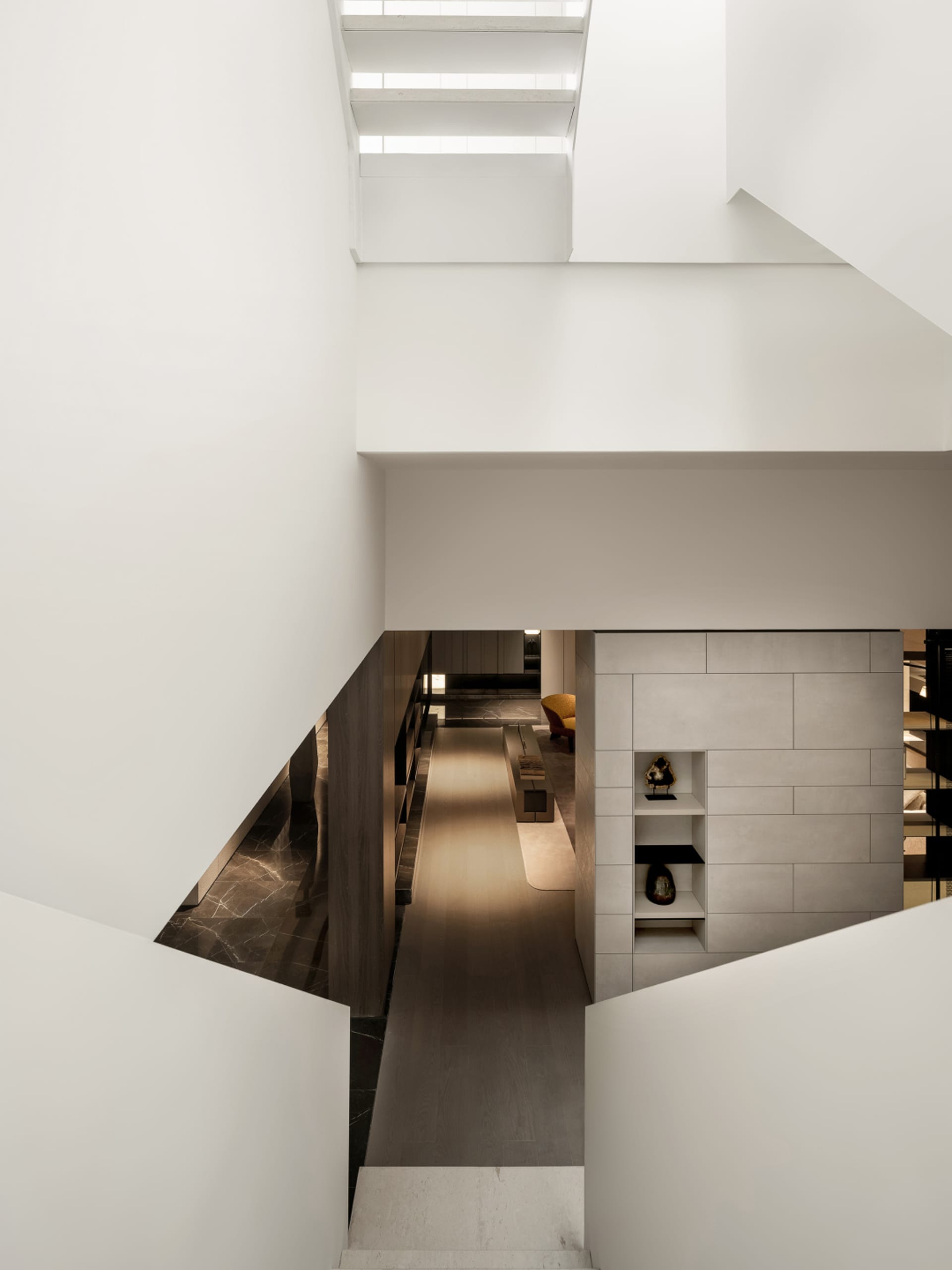 Modern residential interior featuring a sleek, minimalist staircase made of concrete.
