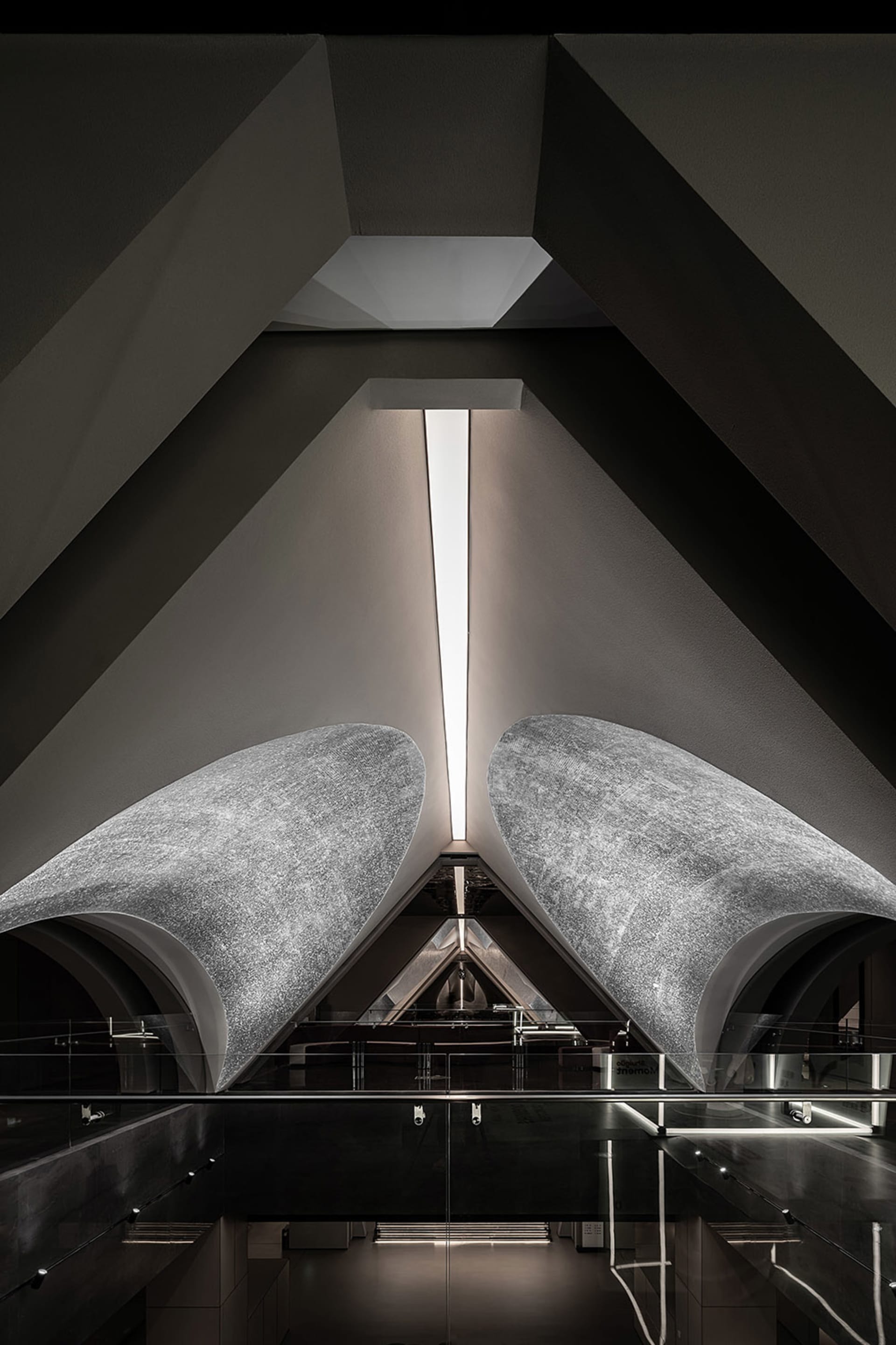 A modern interior space with concrete walls, featuring geometric shapes and a minimalist design.