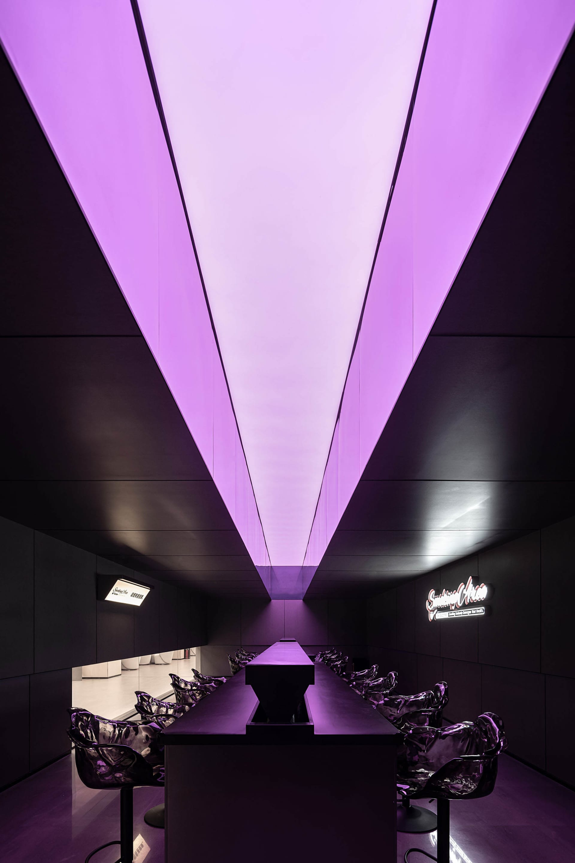 Modern industrial bar with metallic furniture and purple lighting