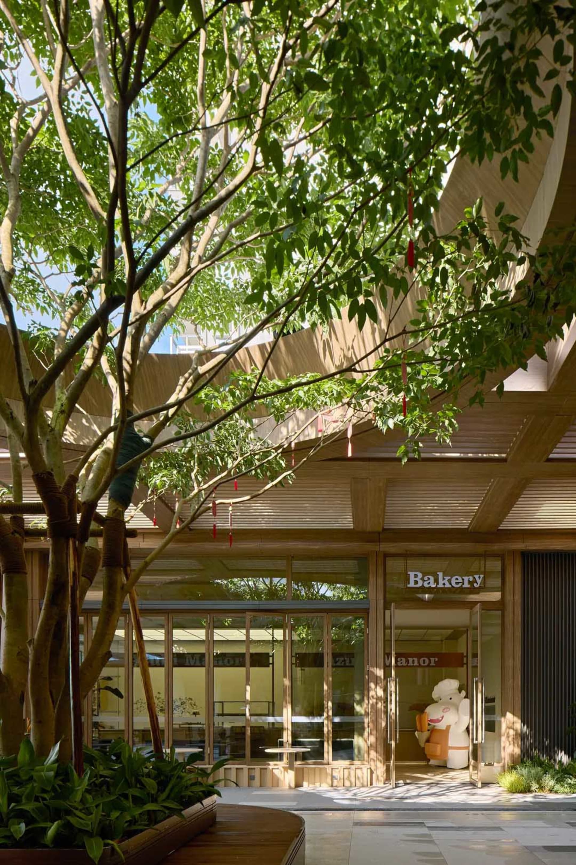 A modern bakery shop with a wooden exterior and large glass windows.
