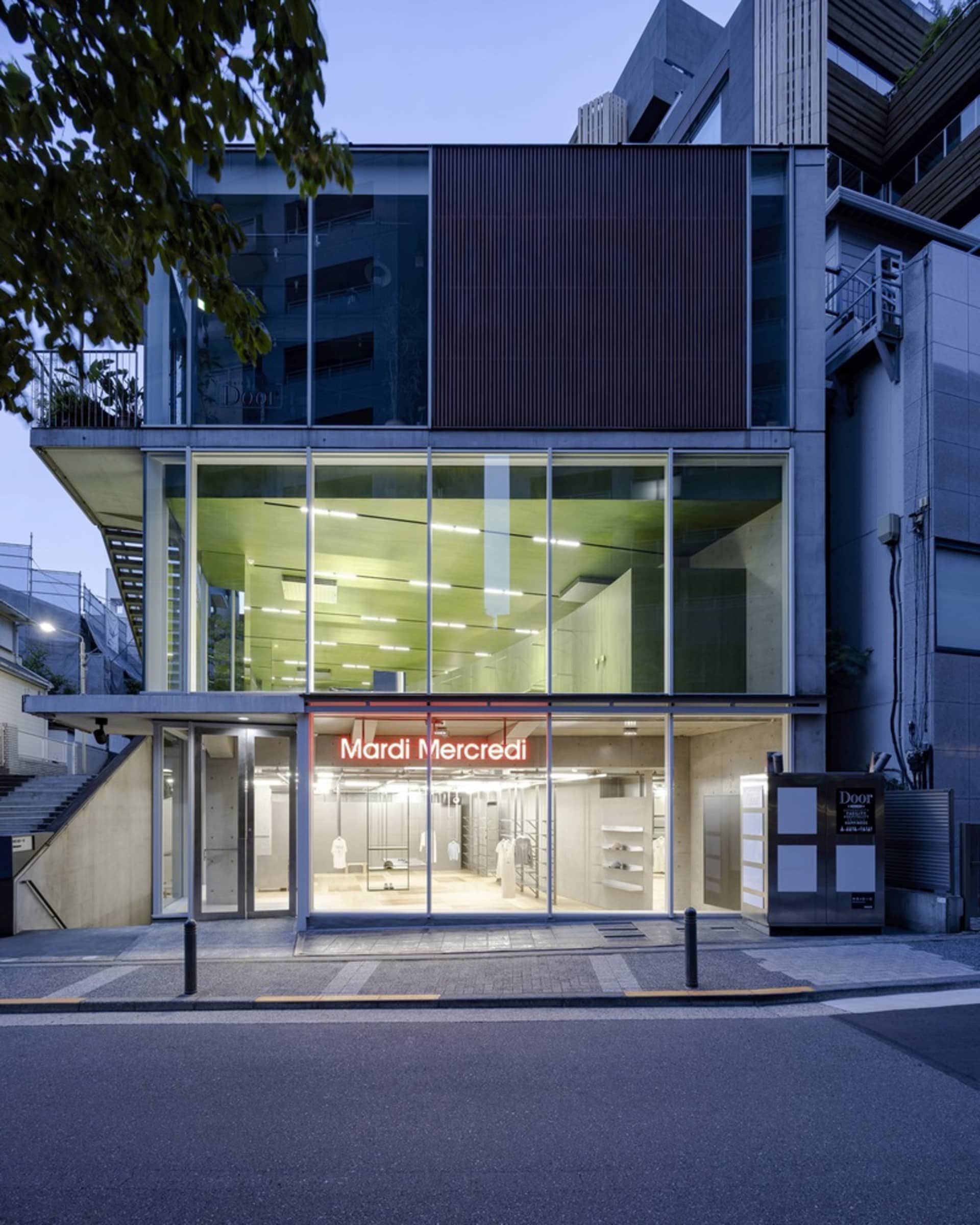 Modern retail storefront with a glass facade, open storefront display, and urban street view.