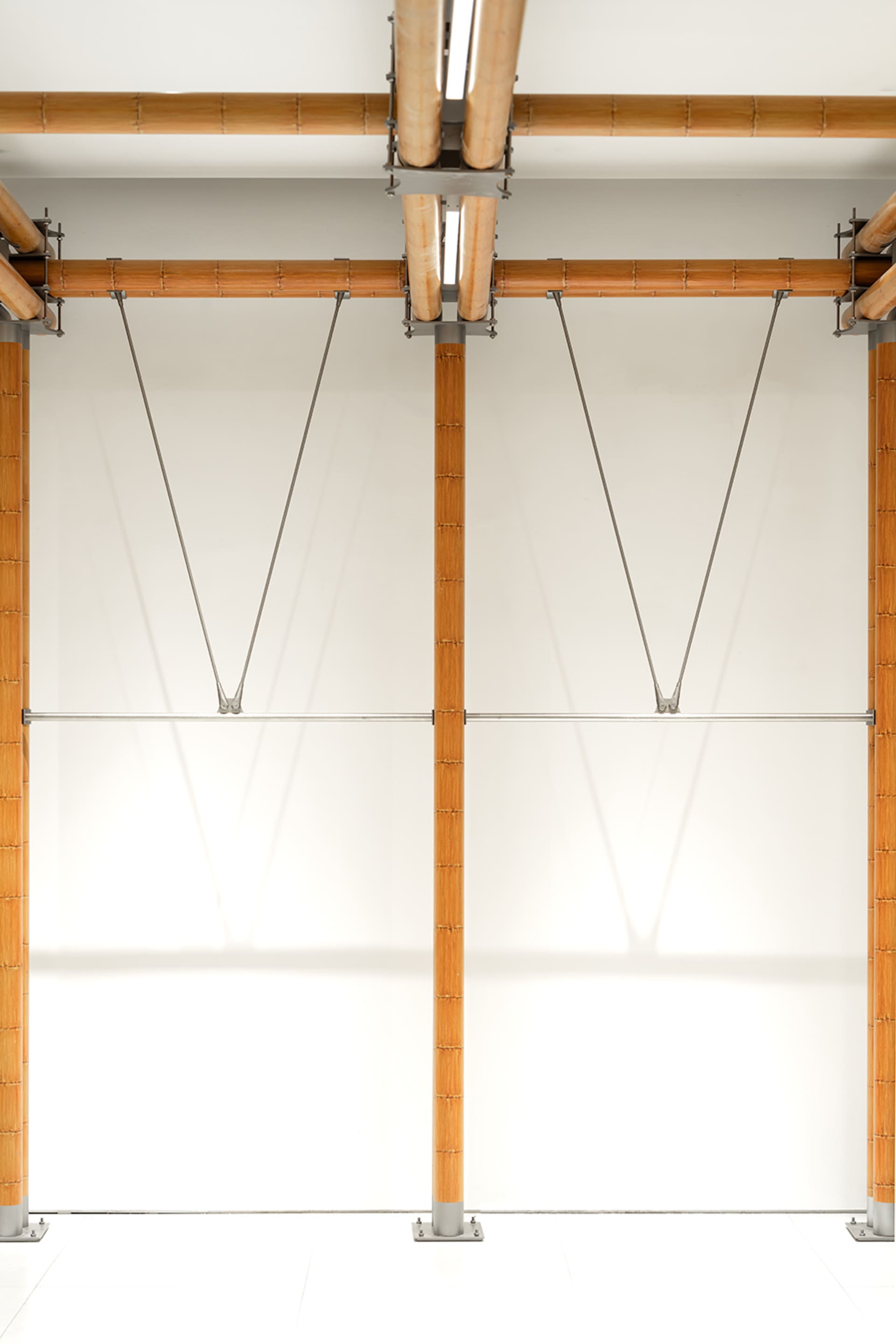 A modern interior design featuring wooden structural elements and lighting.
