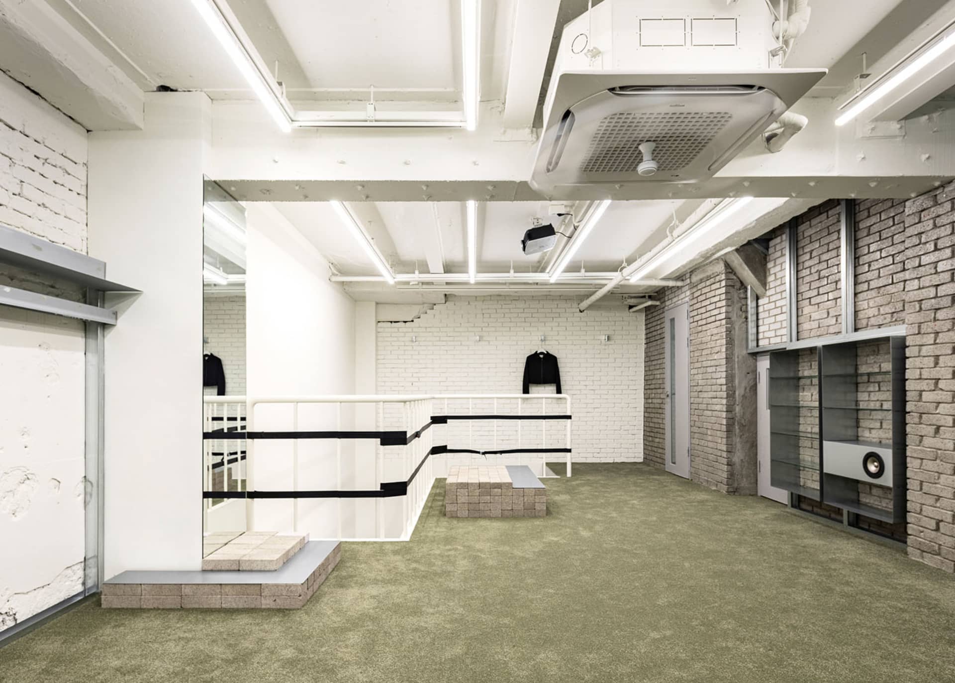 A minimalist, industrial retail space with concrete walls and floors.