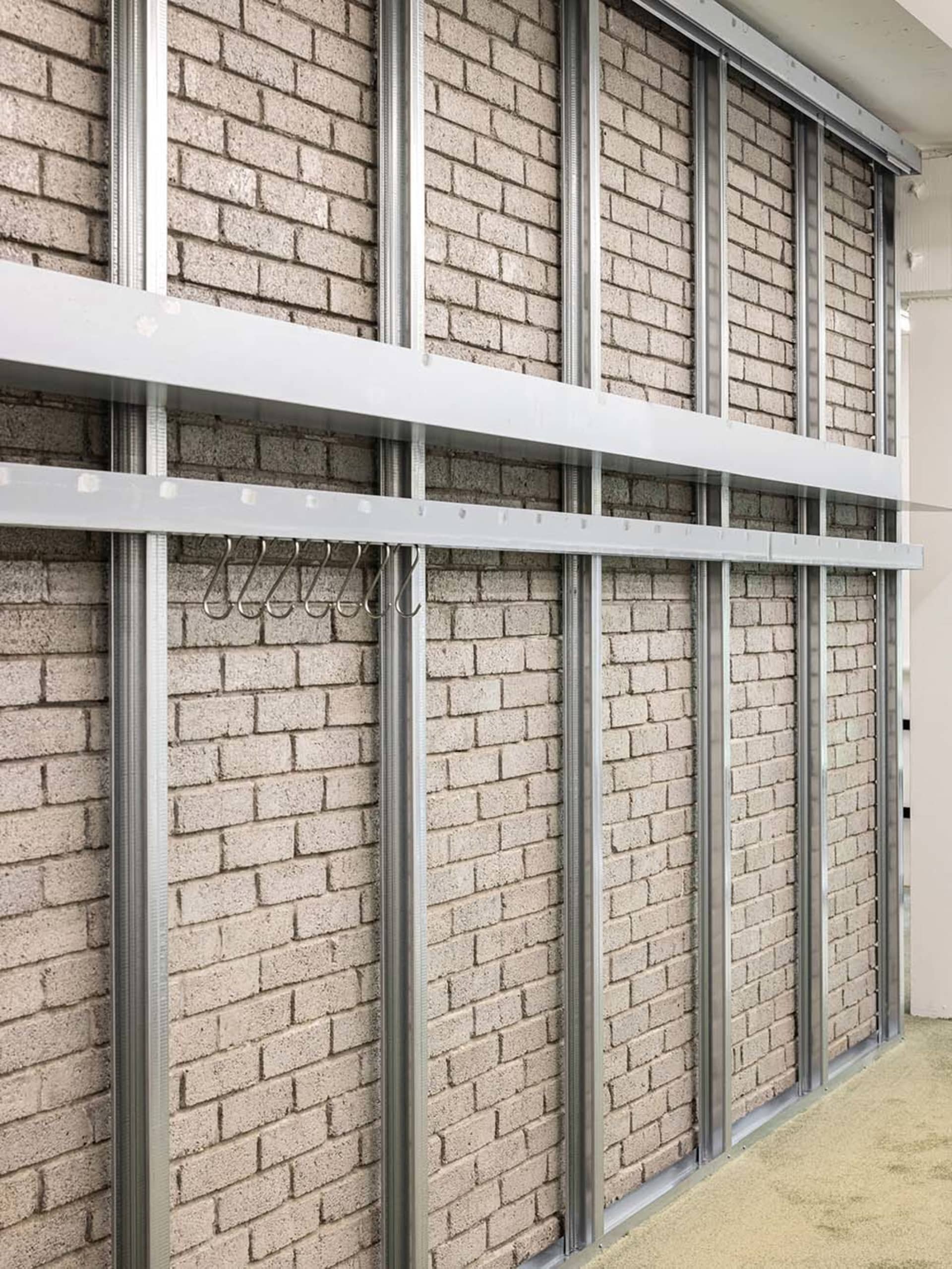 Metallic frame with brick wall in a storage room setting