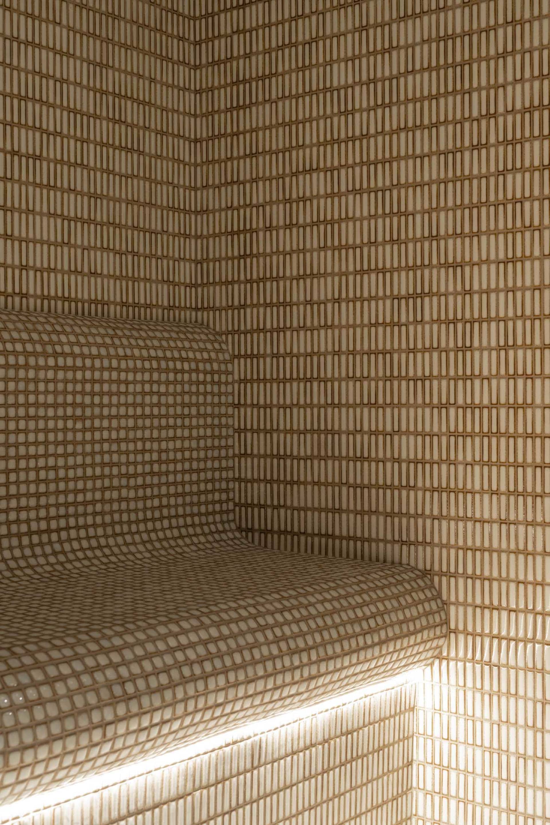Modern bathroom with tiled shower and illuminated lighting