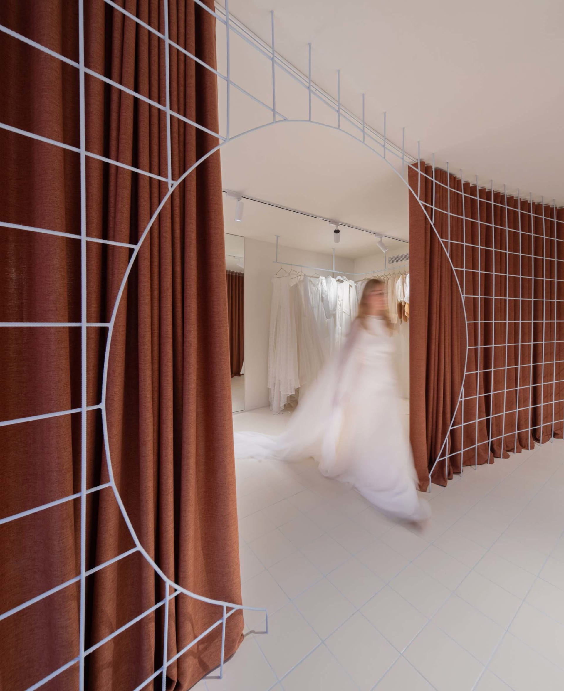 A modern clothing retail shop featuring metal structures and fabric walls