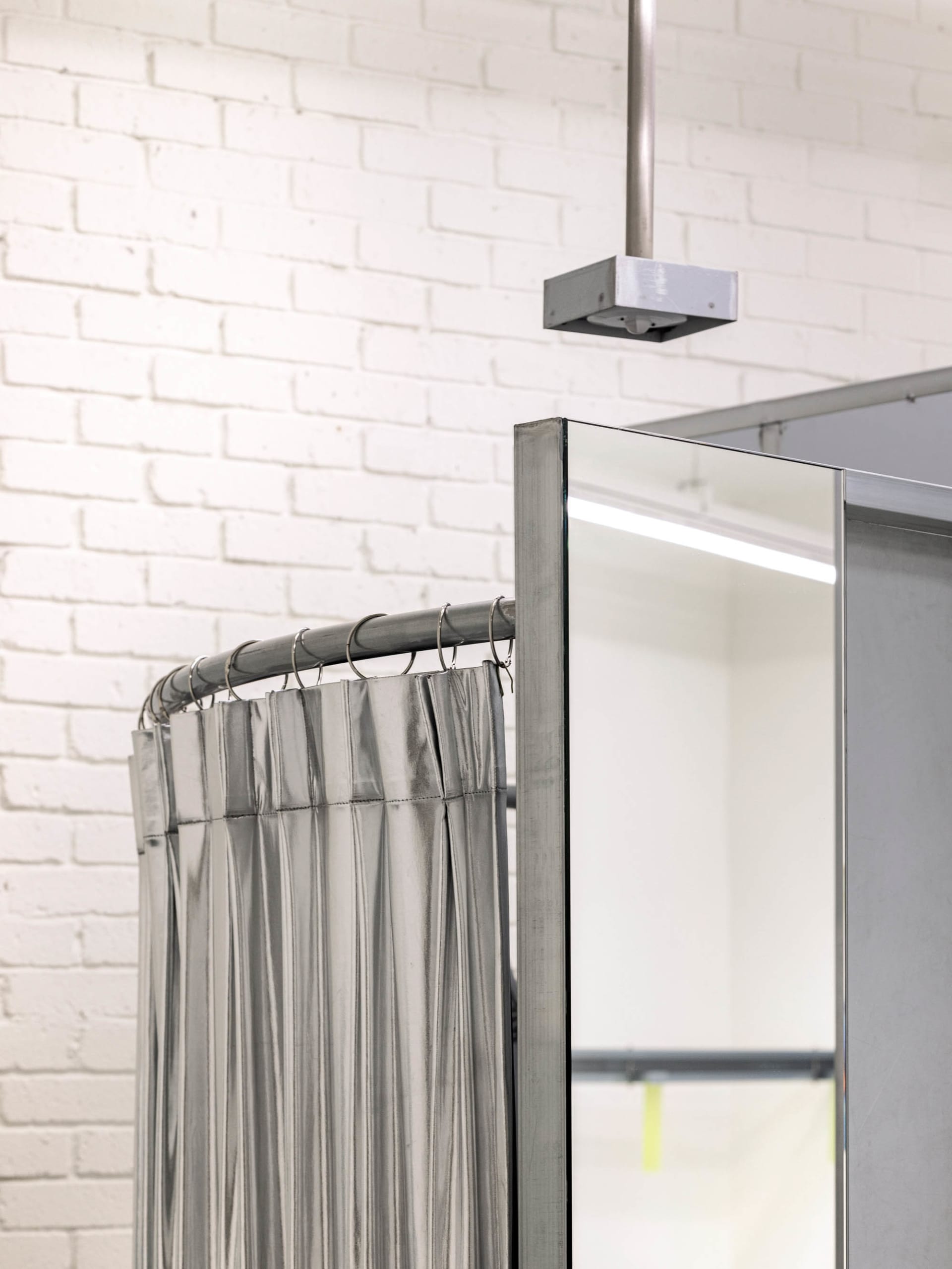 A clothing retail shop with metallic curtains and a glass ceiling.
