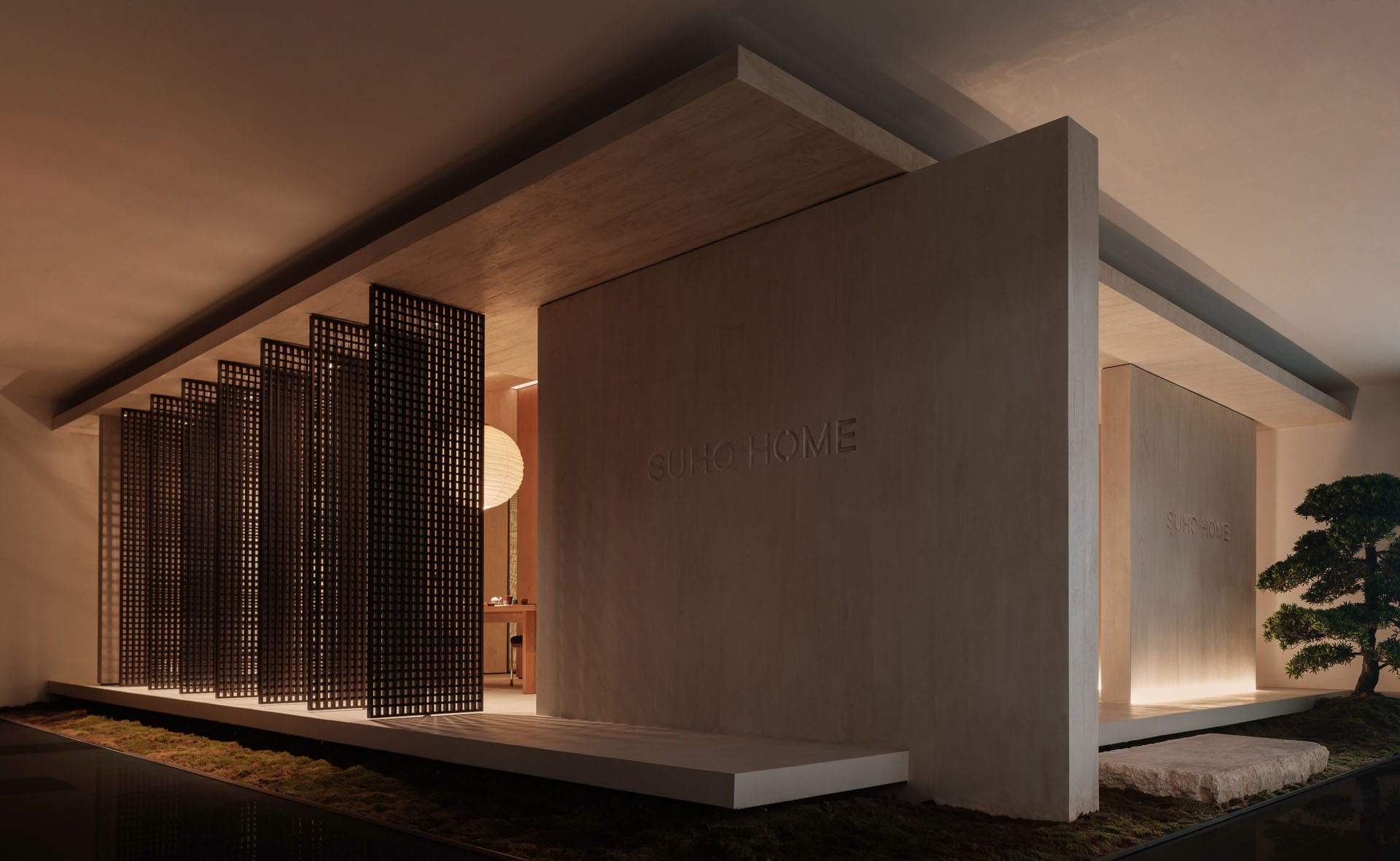 A modern residential entryway featuring a concrete grid system and a bonsai tree.