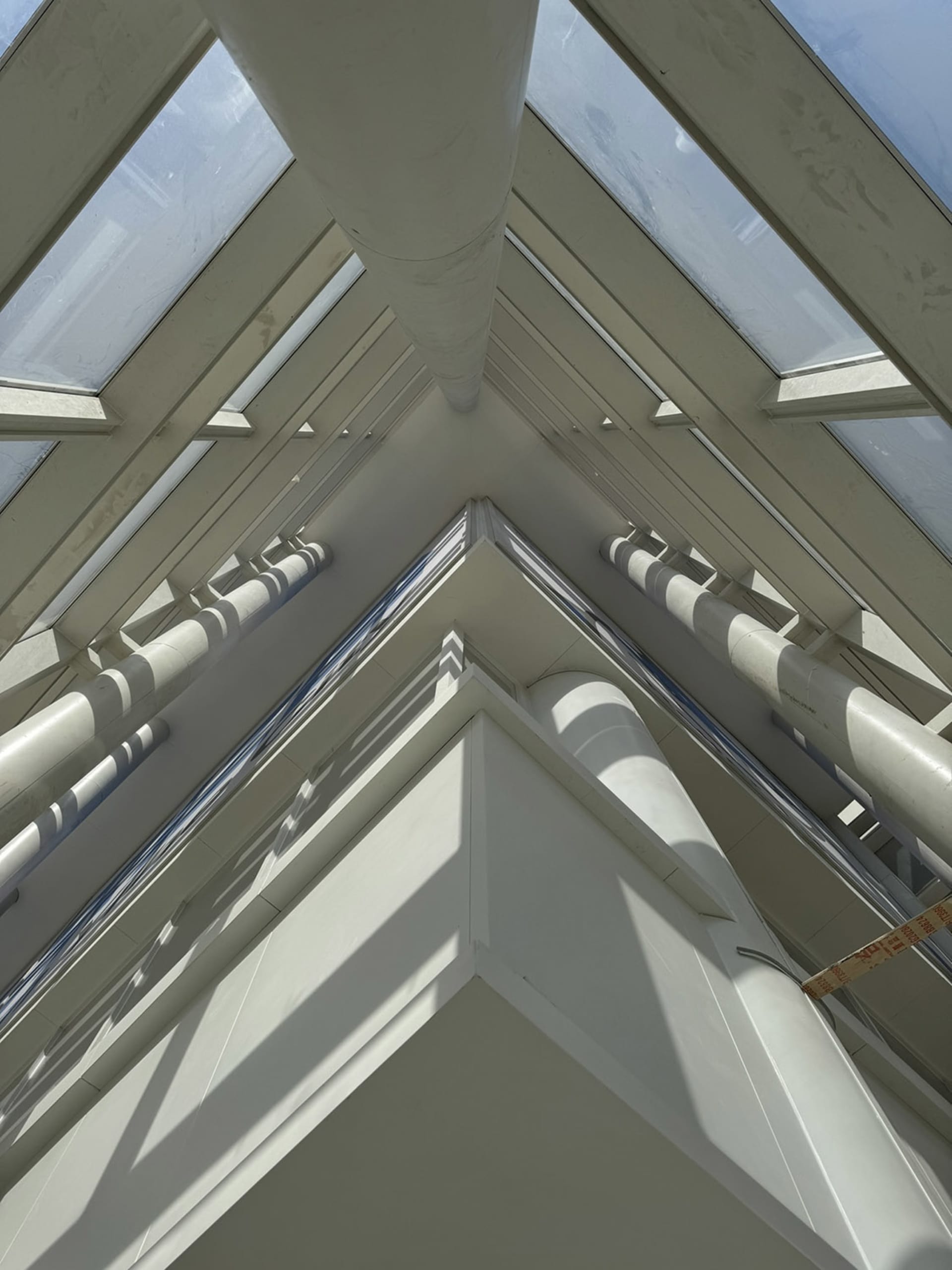 An image of a glass ceiling with modern architectural design