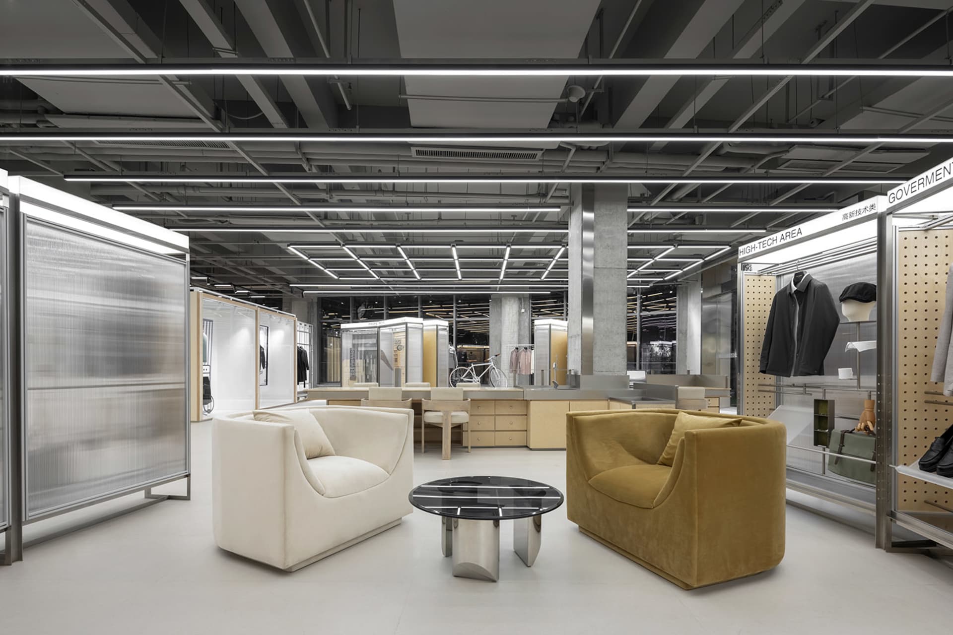 A modern showroom with metal, glass, and fabric materials.